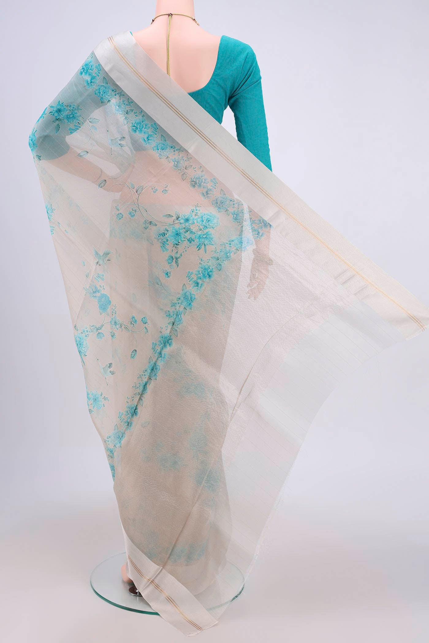 Flat view of Beige Organza Silk Saree with Printed design on the body and Satin Border. 
