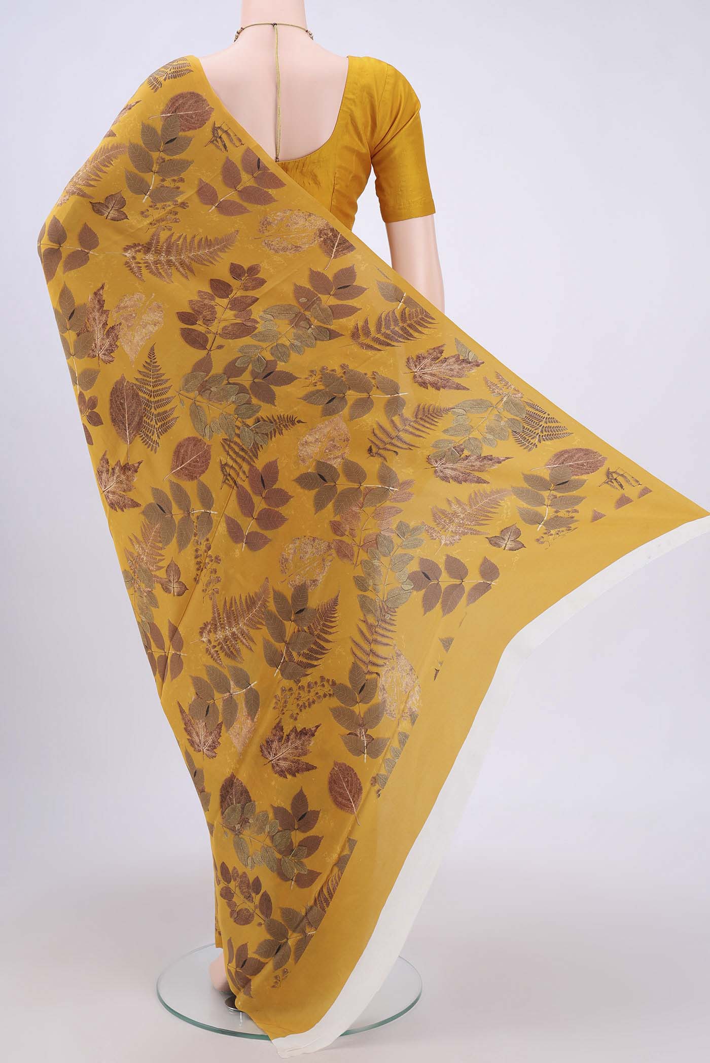 Flat view of Mustard Crepe Saree with Floral Print on the body and Plain Border. 