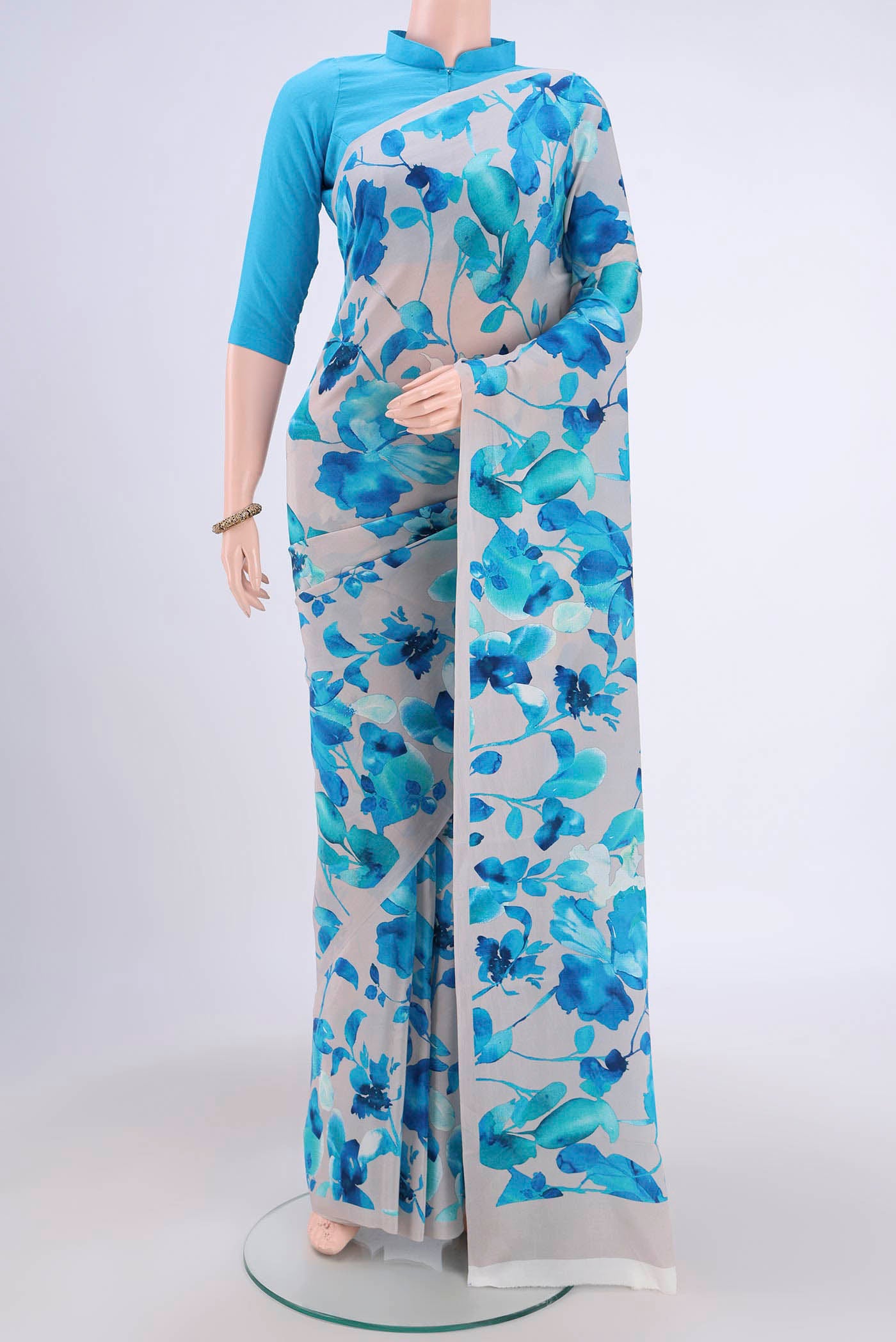 Off White Crepe Saree with Floral Print on the body and Plain Border.  displayed on a mannequin