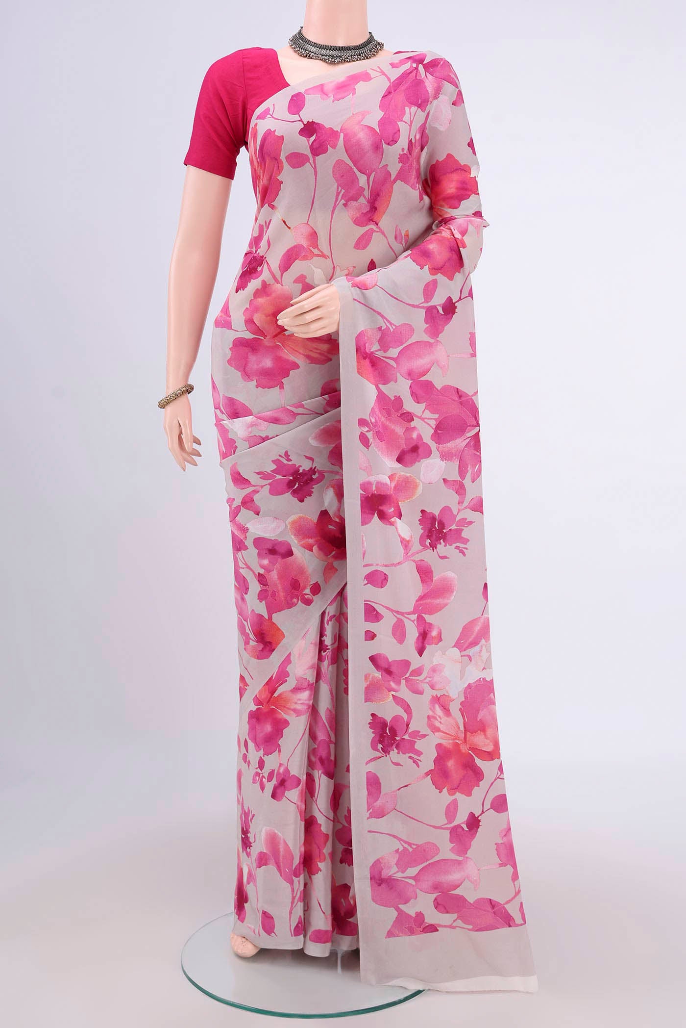 Grey Crepe Saree with Floral Print on the body and Plain Border.  displayed on a mannequin