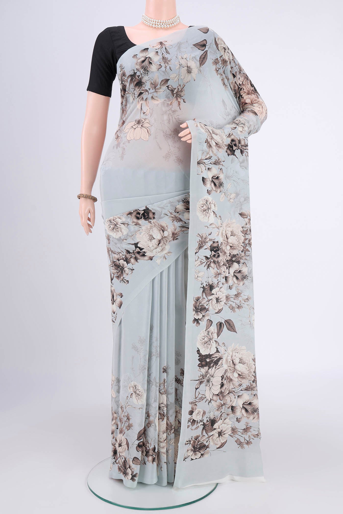 Sky Blue Mysore Crepe Saree with Floral Print on the body and Without Border.  displayed on a mannequin