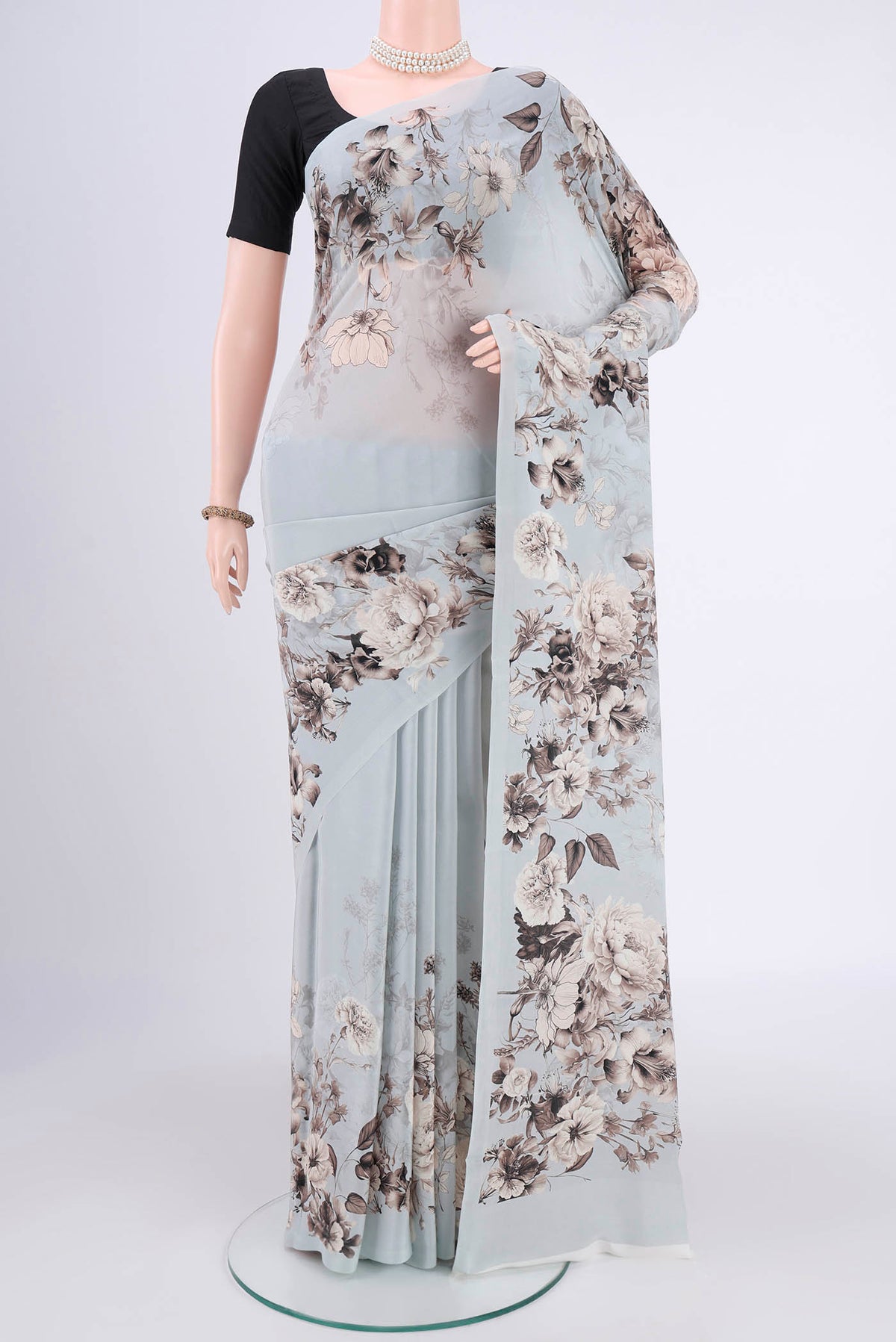 Sky Blue Mysore Crepe Saree with Floral Print on the body and Without Border.  displayed on a mannequin