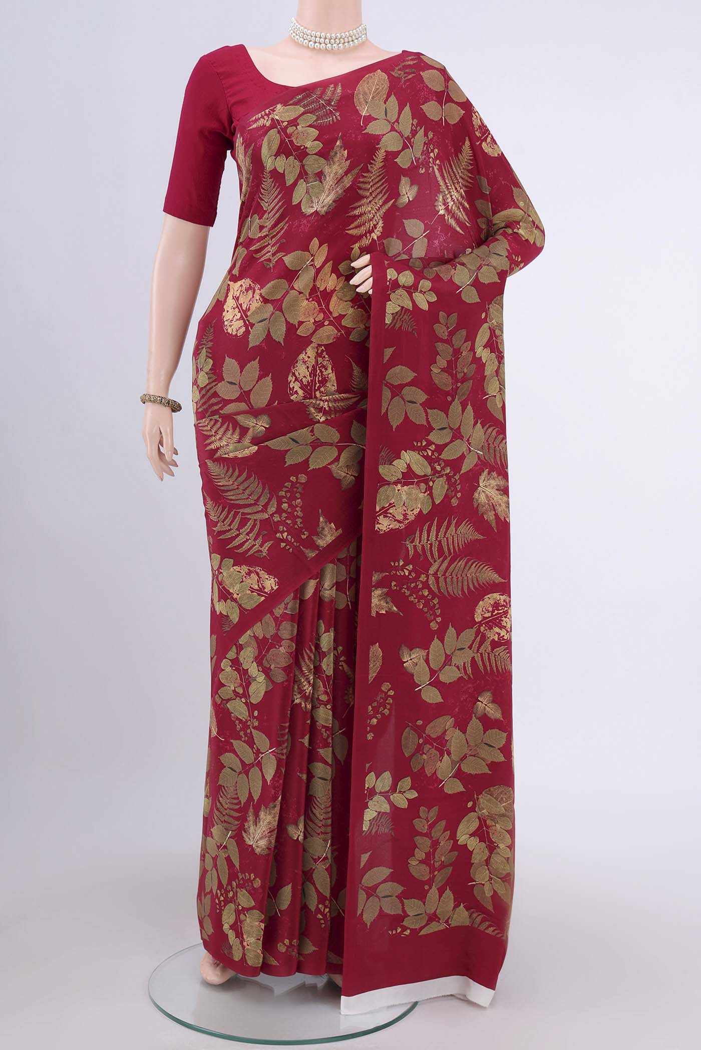 Maroon Crepe Saree with Floral Print on the body and Plain Border.  displayed on a mannequin