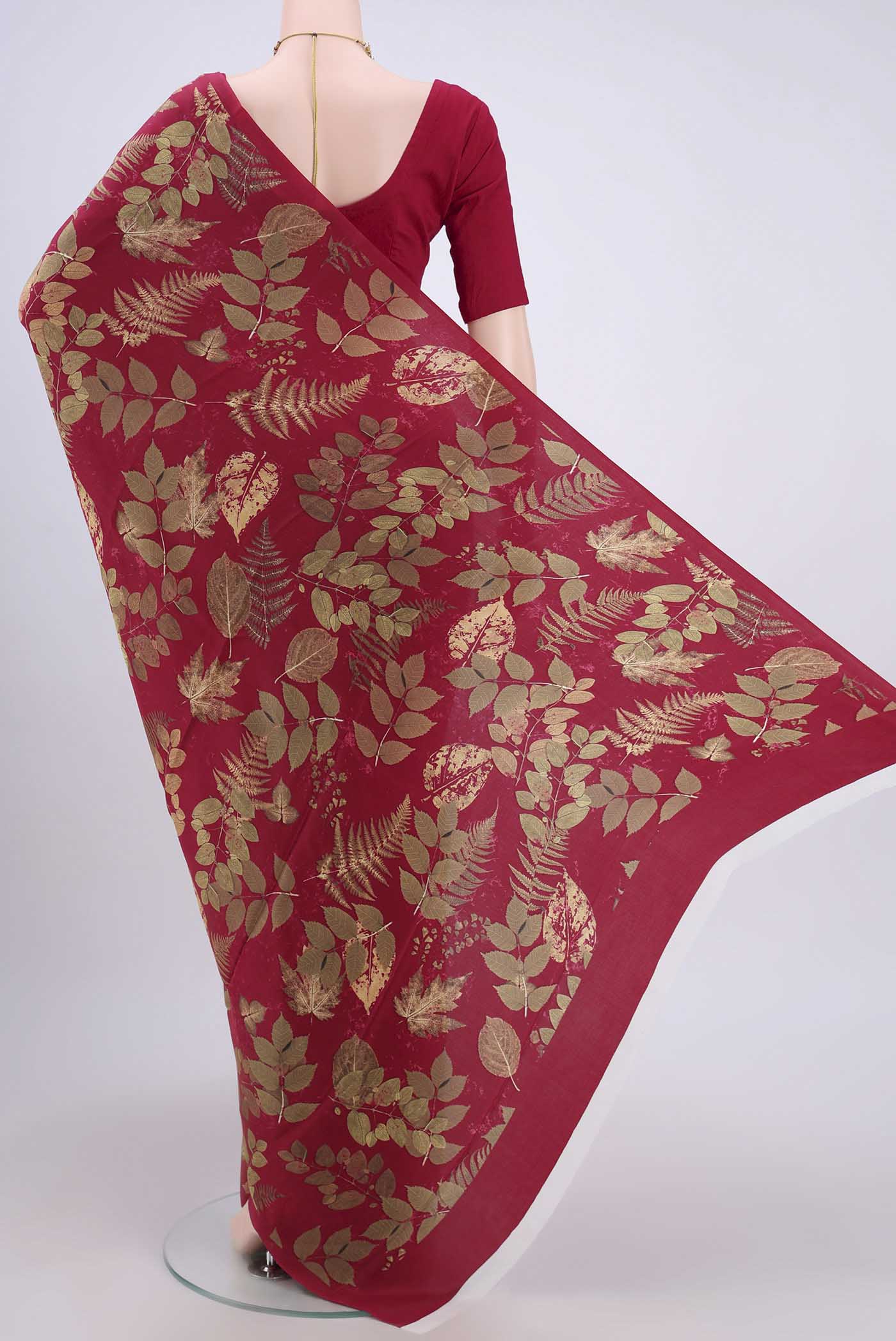 Flat view of Maroon Crepe Saree with Floral Print on the body and Plain Border. 