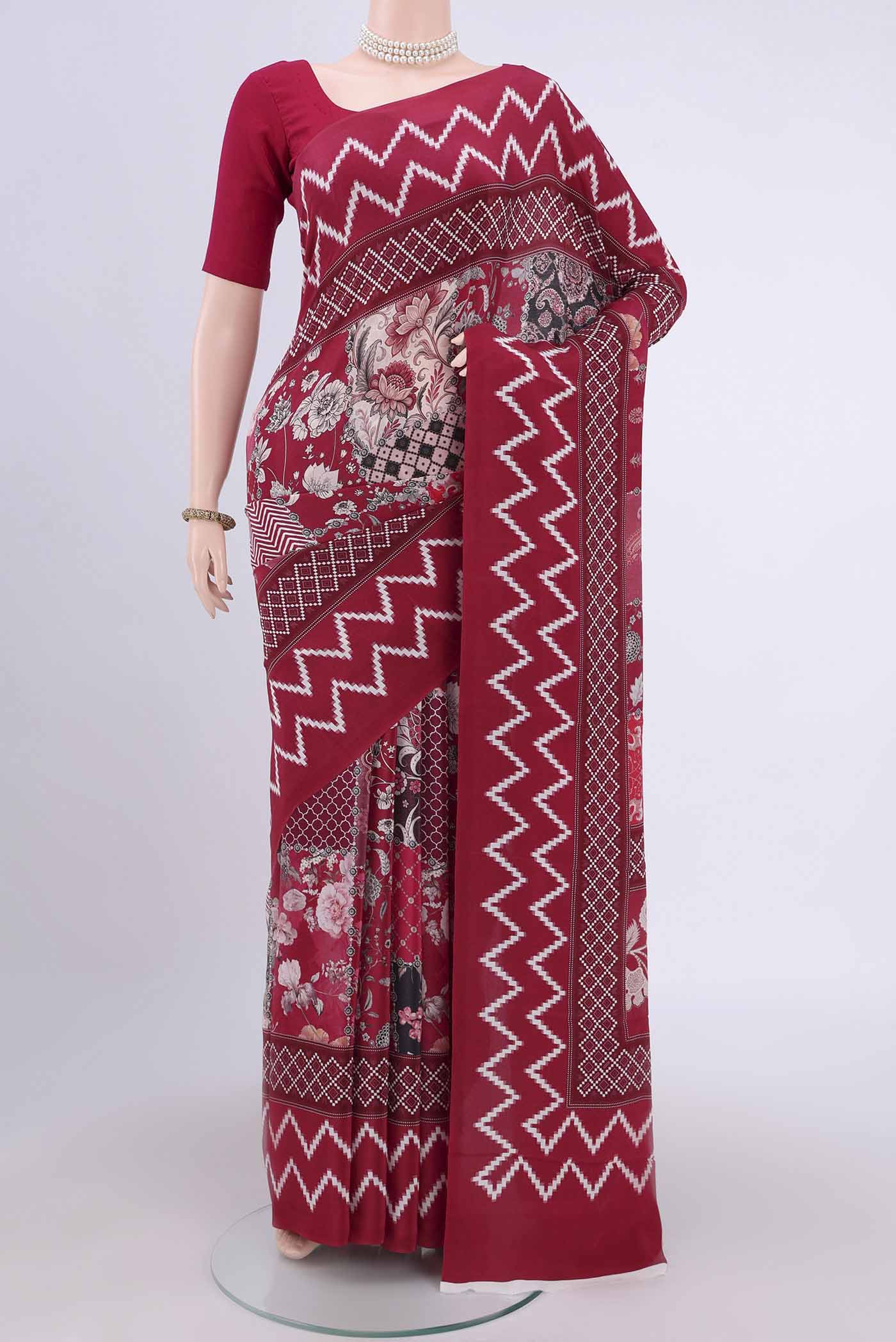 Maroon Crepe Saree with Floral Print on the body and Plain Border.  displayed on a mannequin