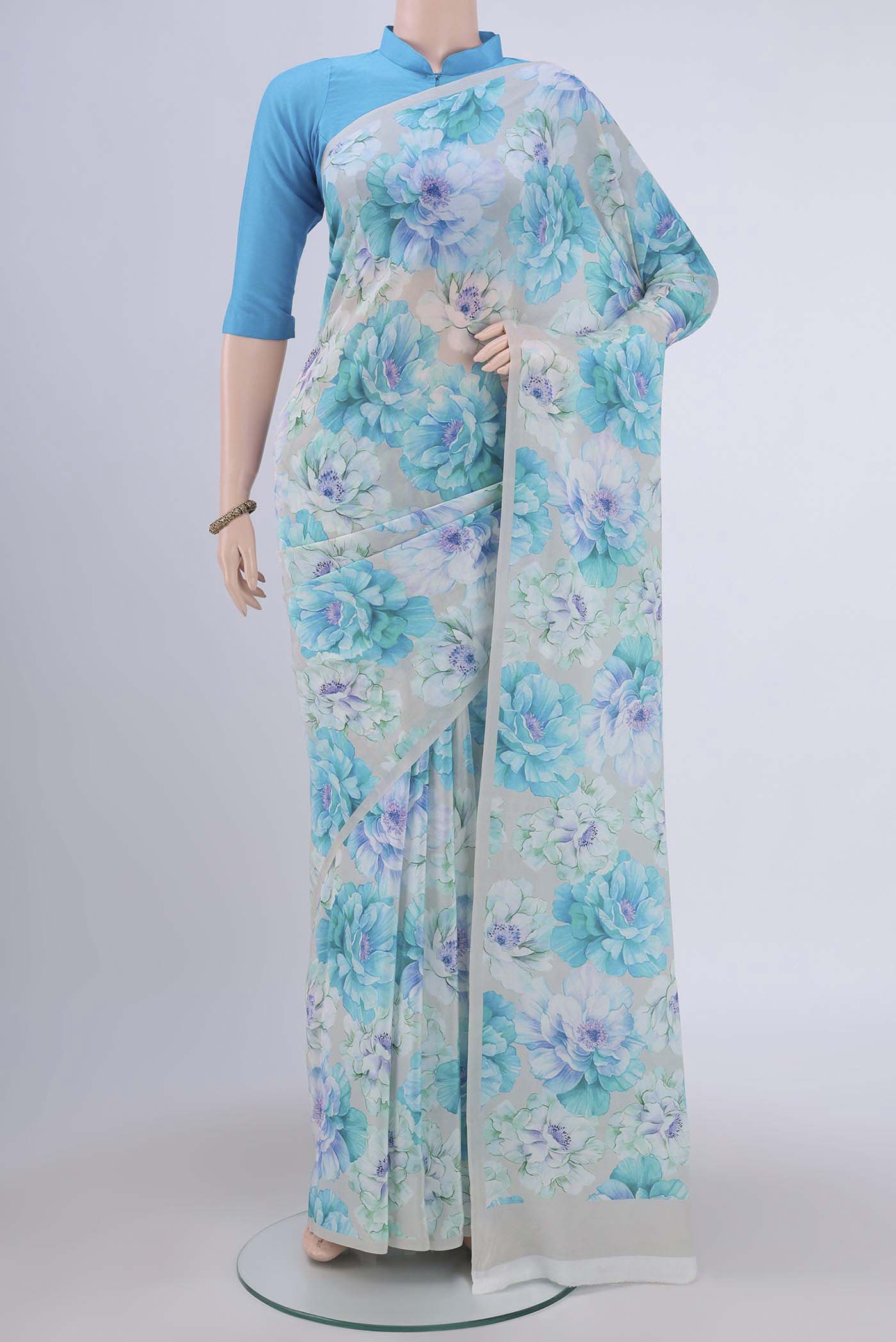 Beige Crepe Saree with Floral Print on the body and Without Border.  displayed on a mannequin