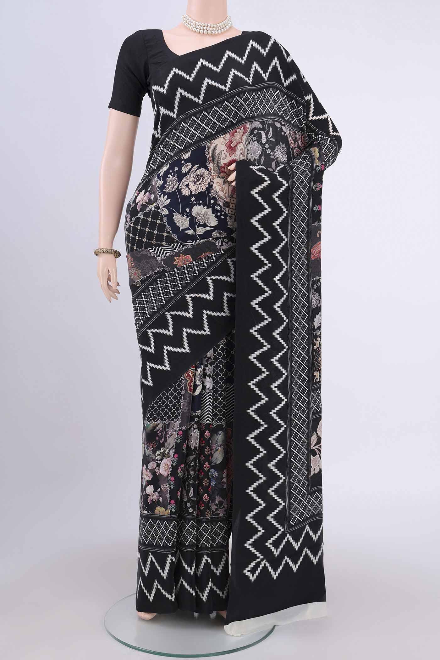 Black Crepe Saree with Floral Print on the body and Plain Border.  displayed on a mannequin