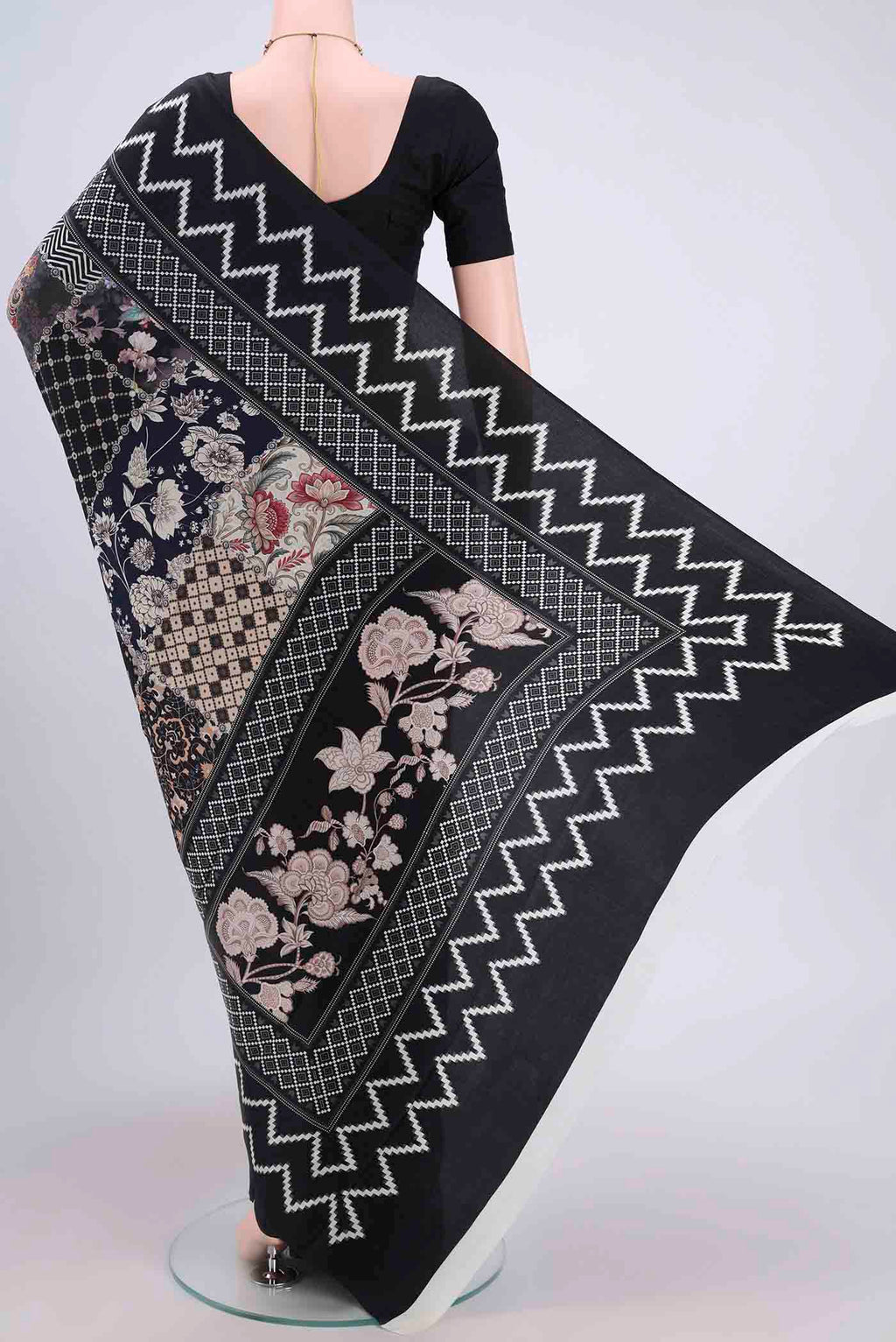 Flat view of Black Crepe Saree with Floral Print on the body and Plain Border. 