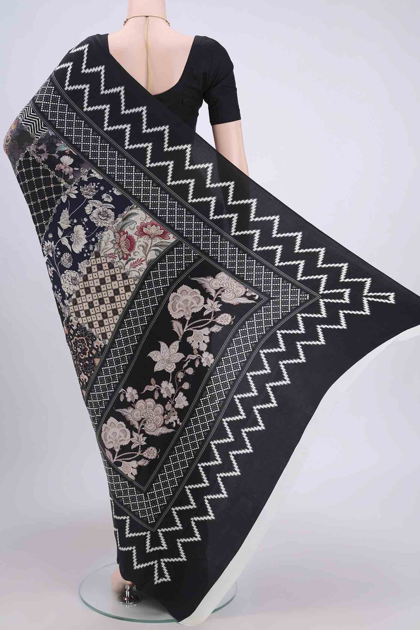 Flat view of Black Crepe Saree with Floral Print on the body and Plain Border. 