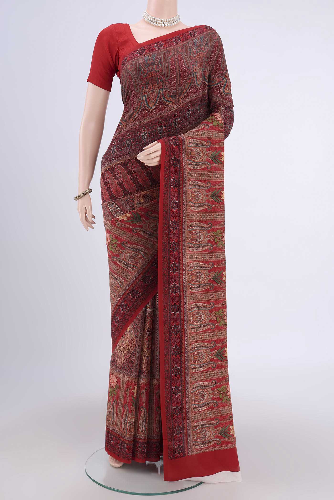 Rust Crepe Saree with Fancy on the body and Plain Border.  displayed on a mannequin