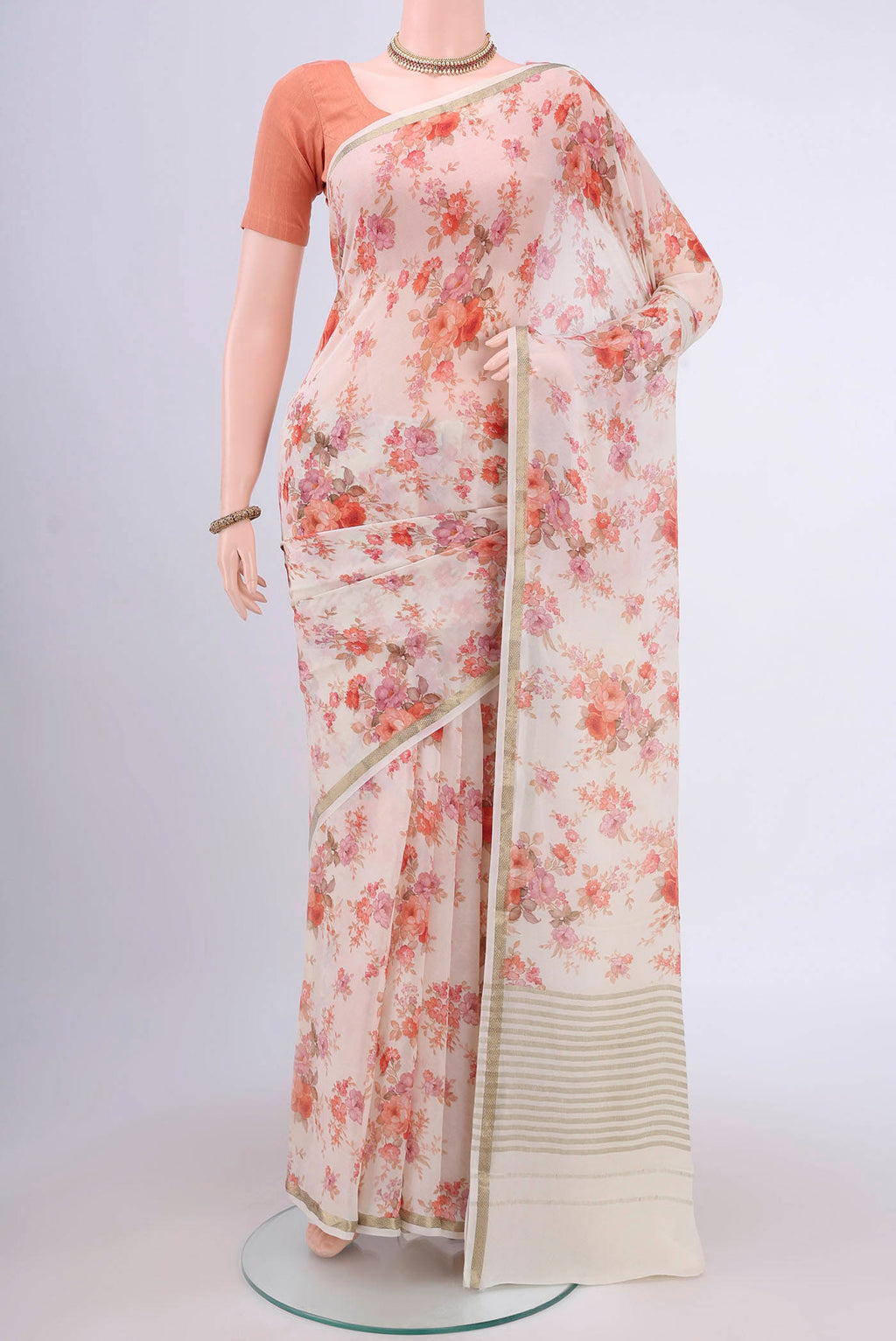 Off White Mysore Crepe Saree with Floral Print on the body and Printed Border.  displayed on a mannequin