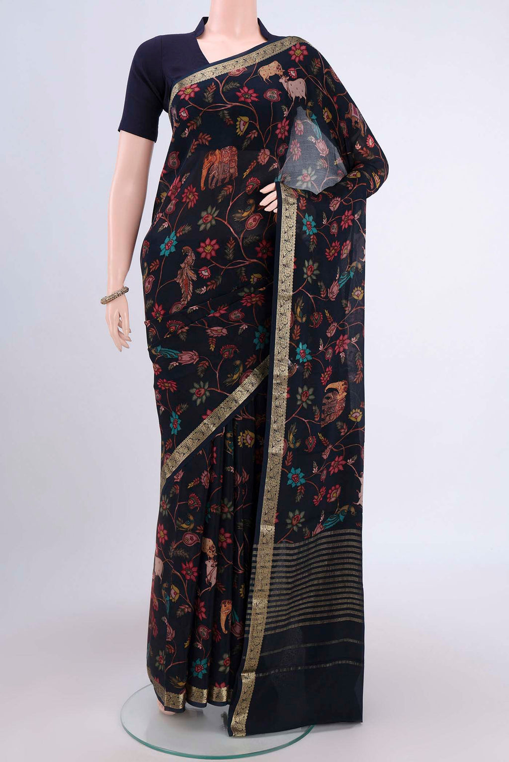 Black Crepe Saree with Floral Print on the body and Plain Border.  displayed on a mannequin