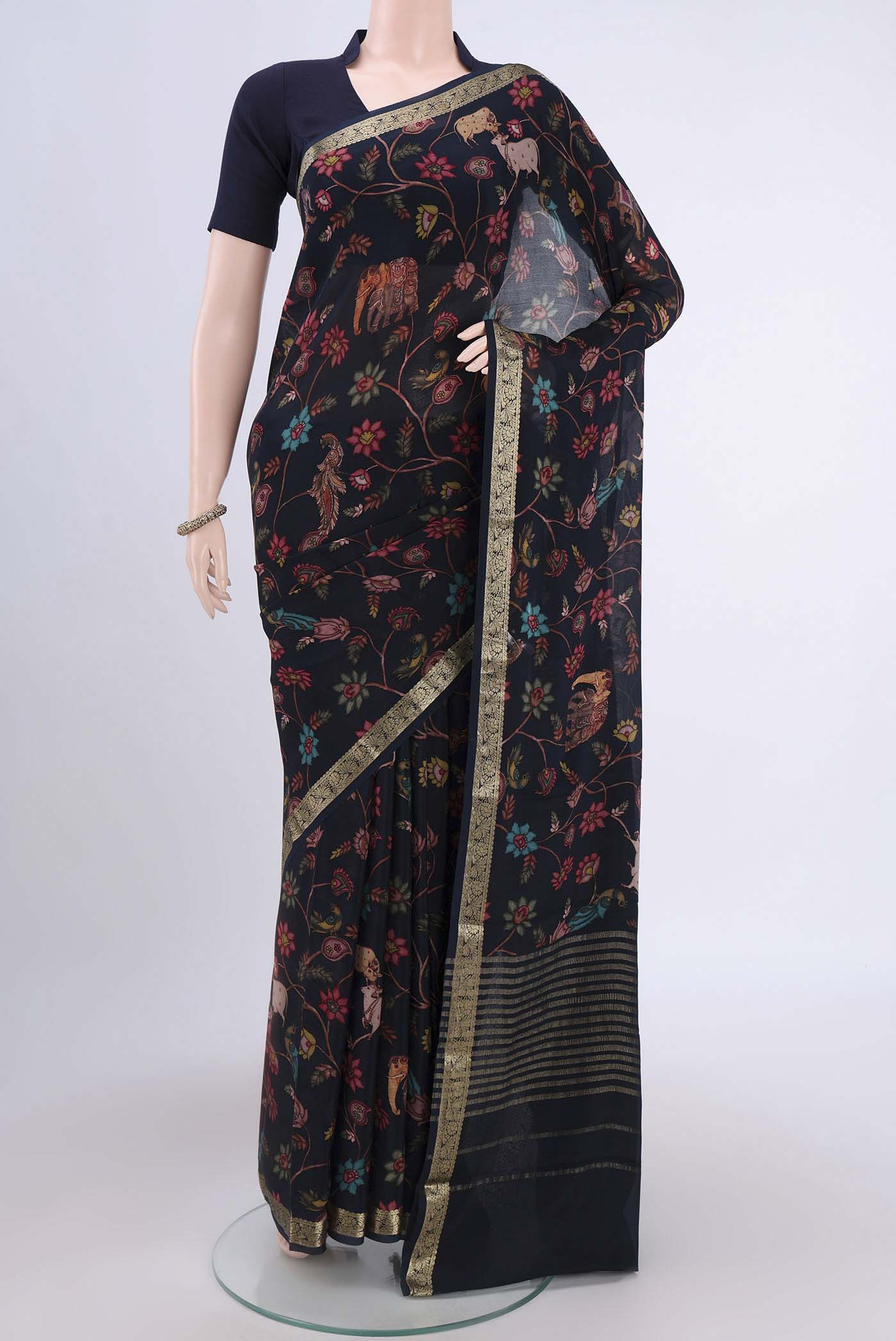 Black Crepe Saree with Floral Print on the body and Plain Border.  displayed on a mannequin