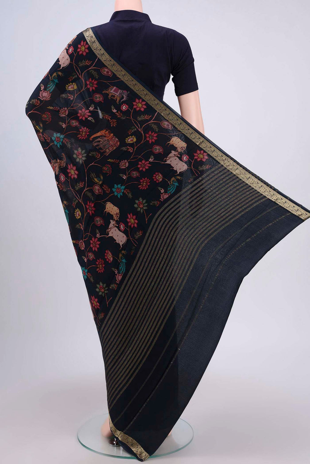 Flat view of Black Crepe Saree with Floral Print on the body and Plain Border. 