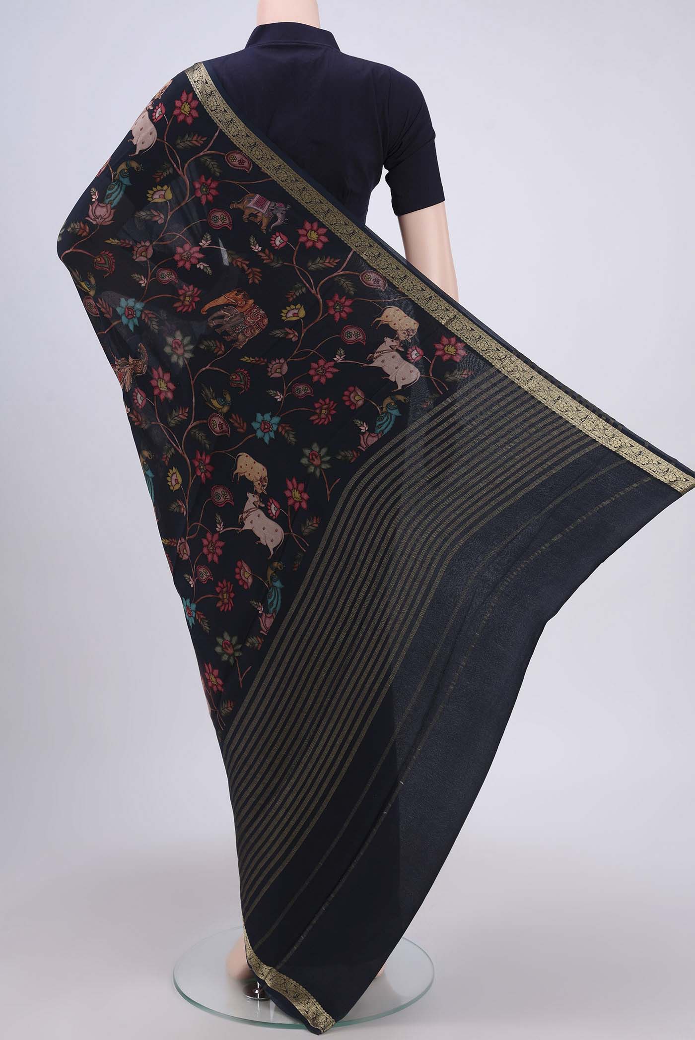 Flat view of Black Crepe Saree with Floral Print on the body and Plain Border. 
