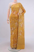 Mustard Crepe Saree with Floral Print on the body and Zari Border.  displayed on a mannequin