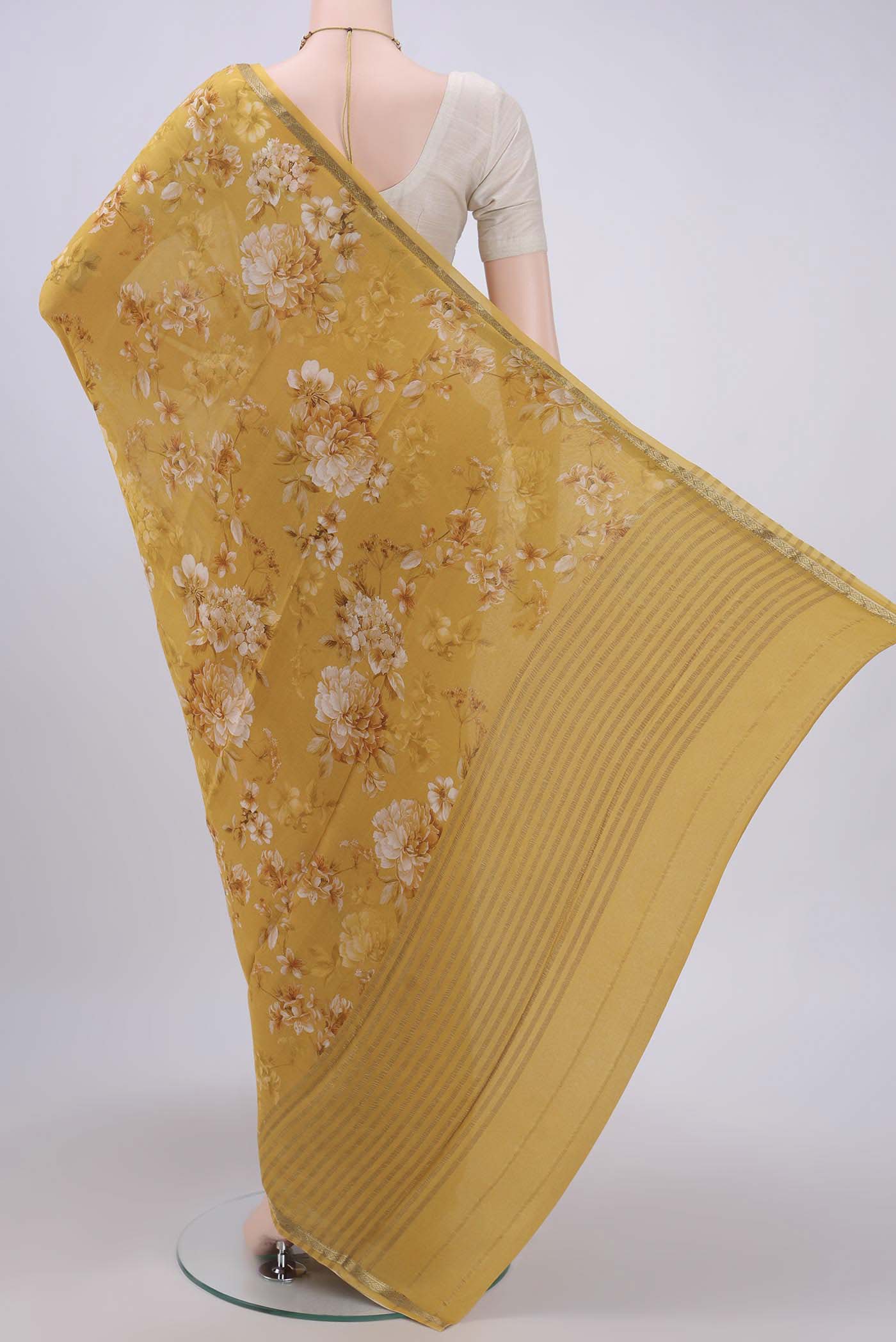 Flat view of Mustard Crepe Saree with Floral Print on the body and Zari Border. 