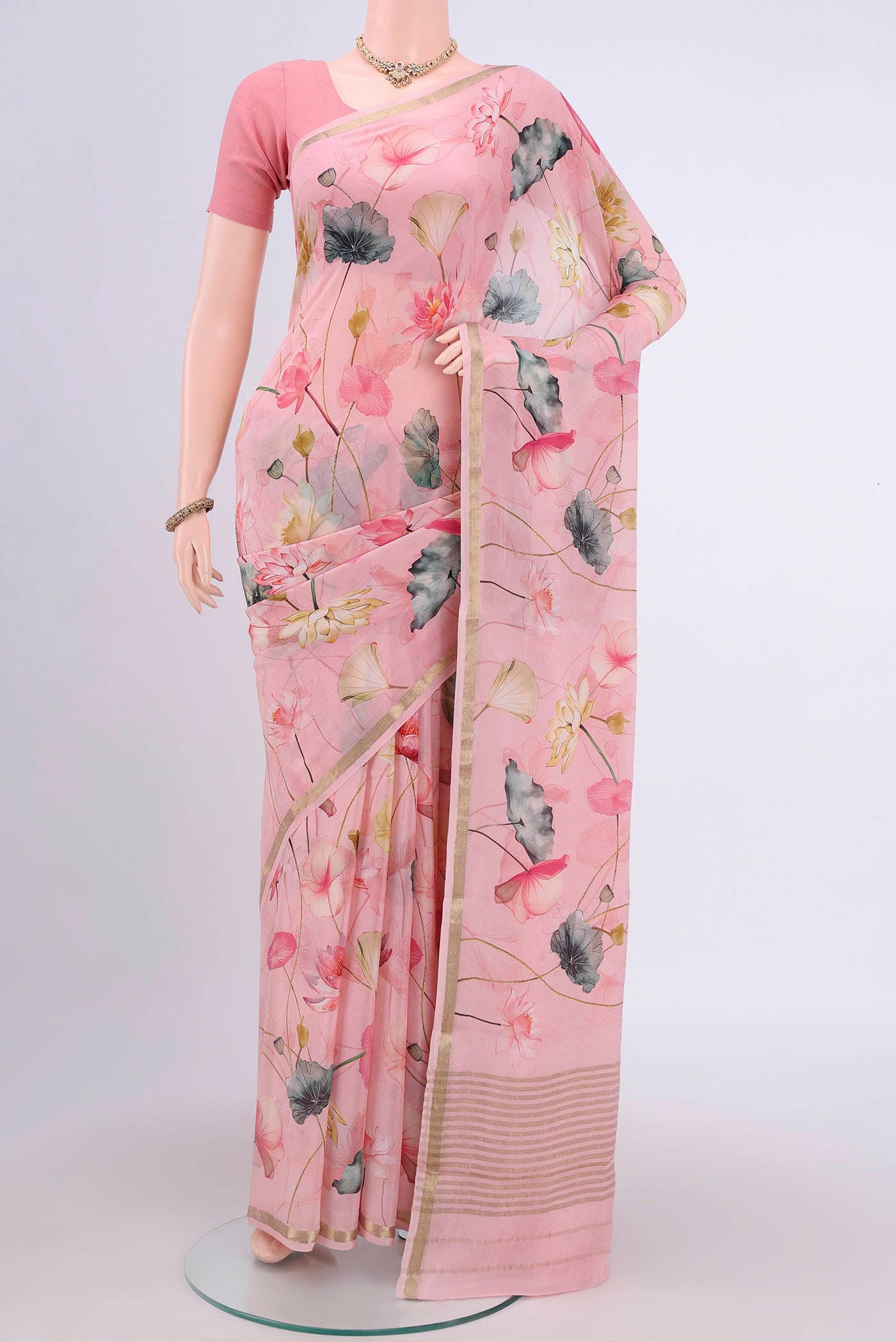 Rose pink Crepe Saree with Floral Print on the body and Plain Border.  displayed on a mannequin