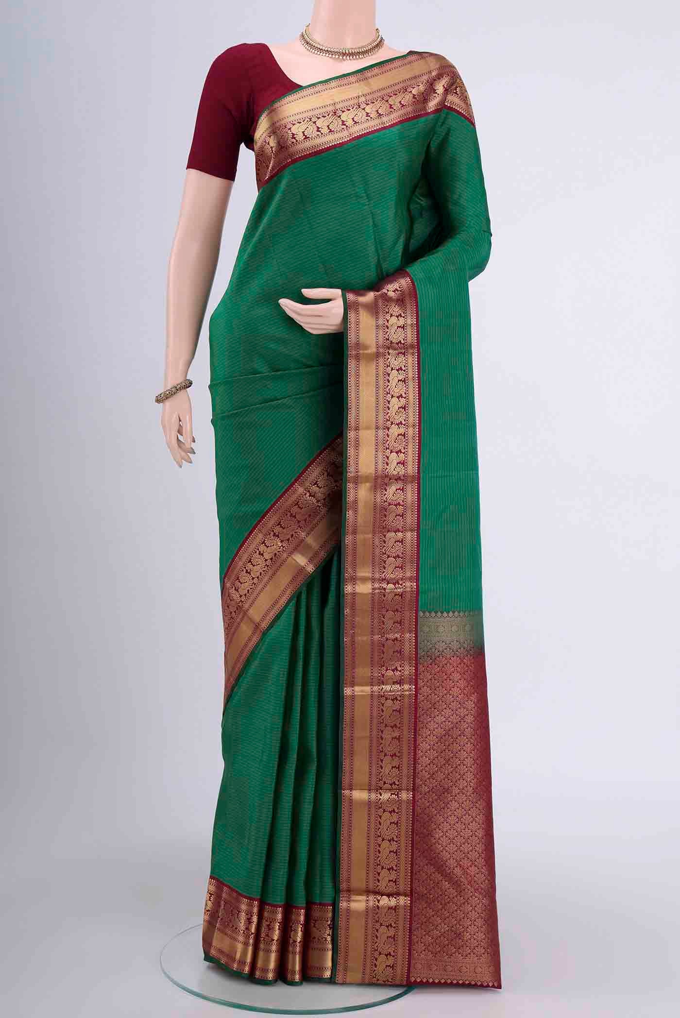 Green Dual Tone Nangavalli Silk [ Salem ] Saree with Zari Butta on the body and Zari Border displayed on a mannequin