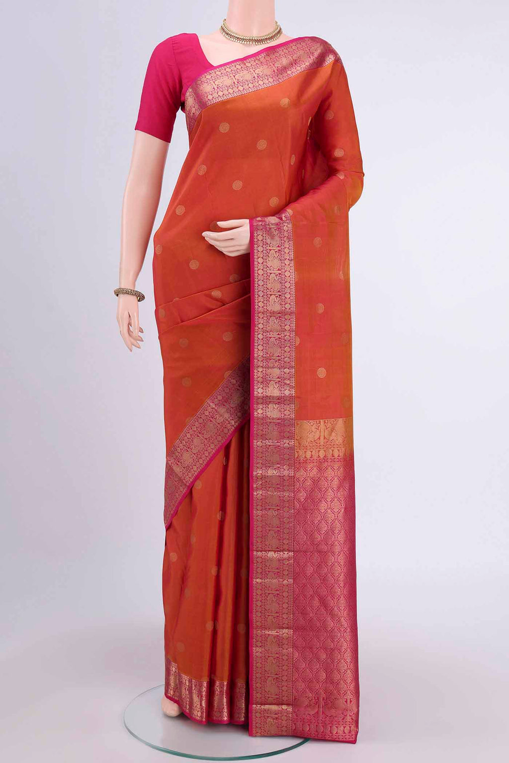 Brick Orange Dual Tone Nangavalli Silk [ Salem ] Saree with Zari Butta on the body and Zari Border displayed on a mannequin