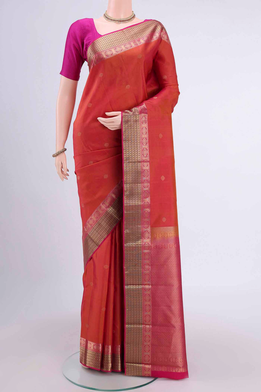 Brick Orange Dual Tone Nangavalli Silk [ Salem ] Saree with Zari Butta on the body and Zari Border displayed on a mannequin
