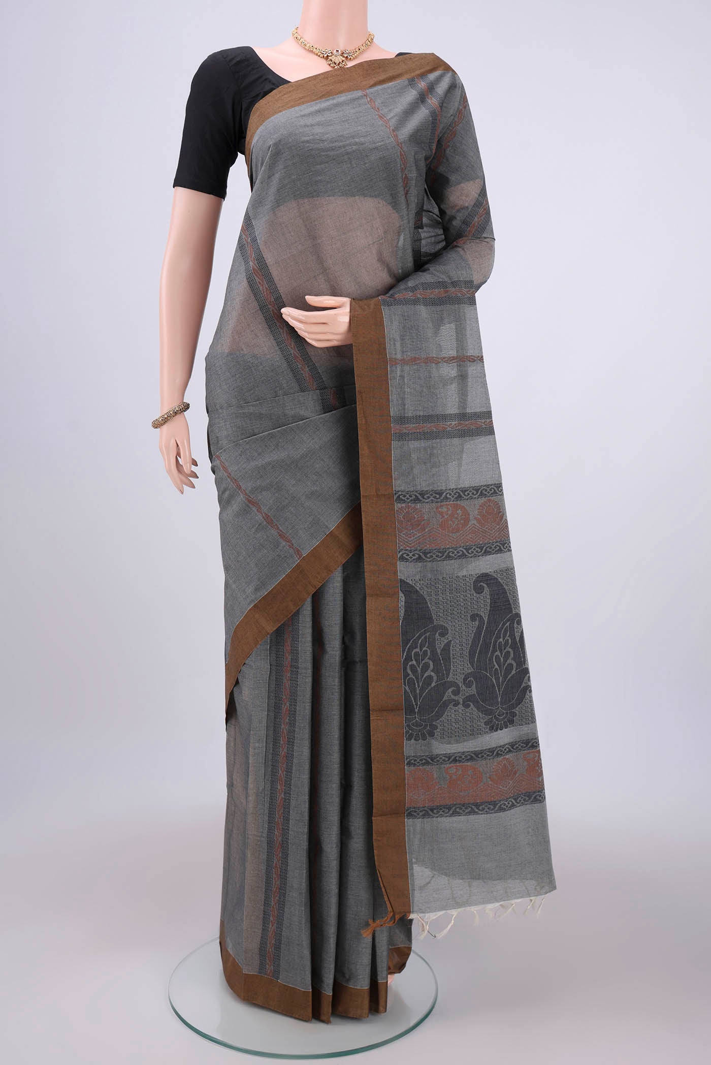 Grey Kanchi Cotton Saree with Stripes on the body and Thread Border.  displayed on a mannequin