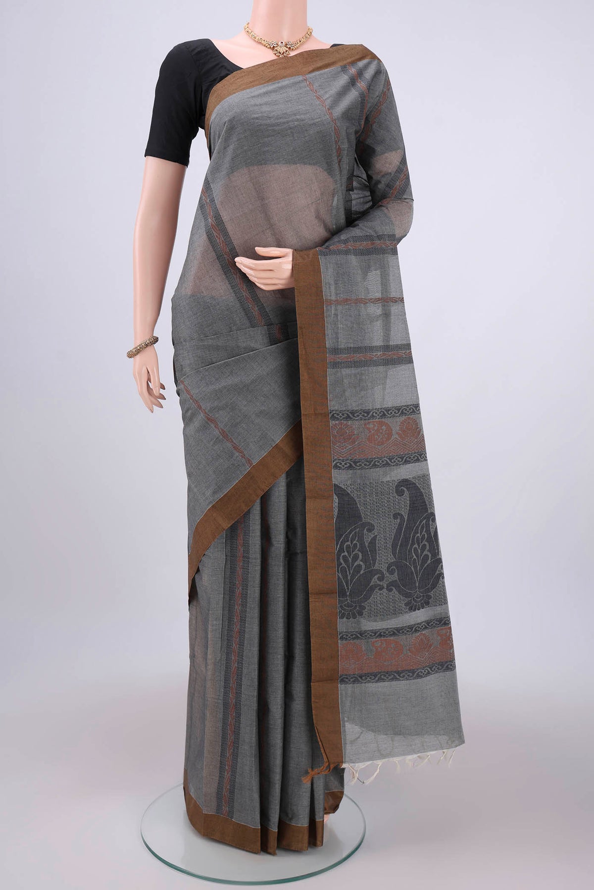 Grey Kanchi Cotton Saree with Stripes on the body and Thread Border.  displayed on a mannequin