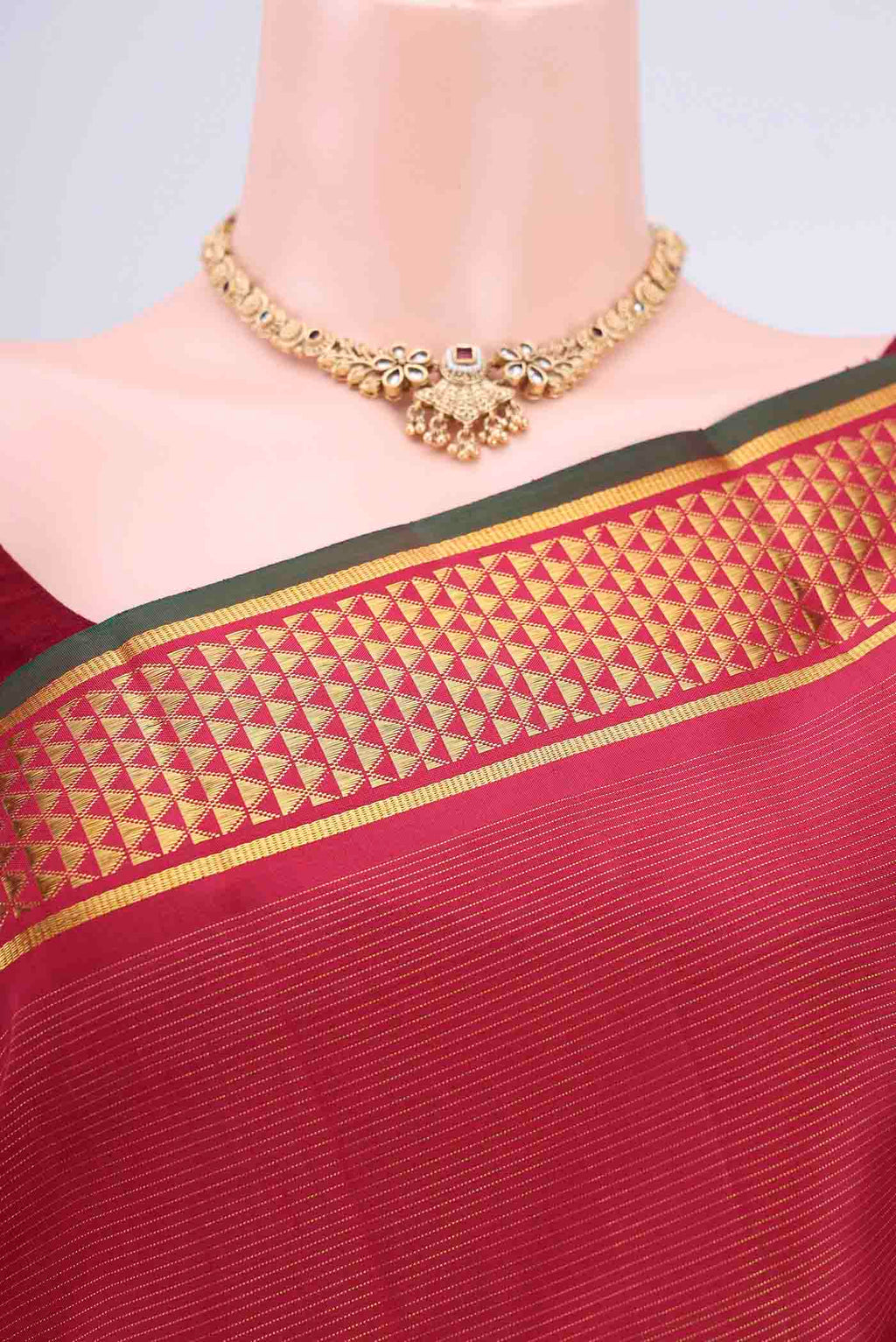 Border image of Maroon Kanchipuram Saree with Stripes on the body and Zari Border. 
