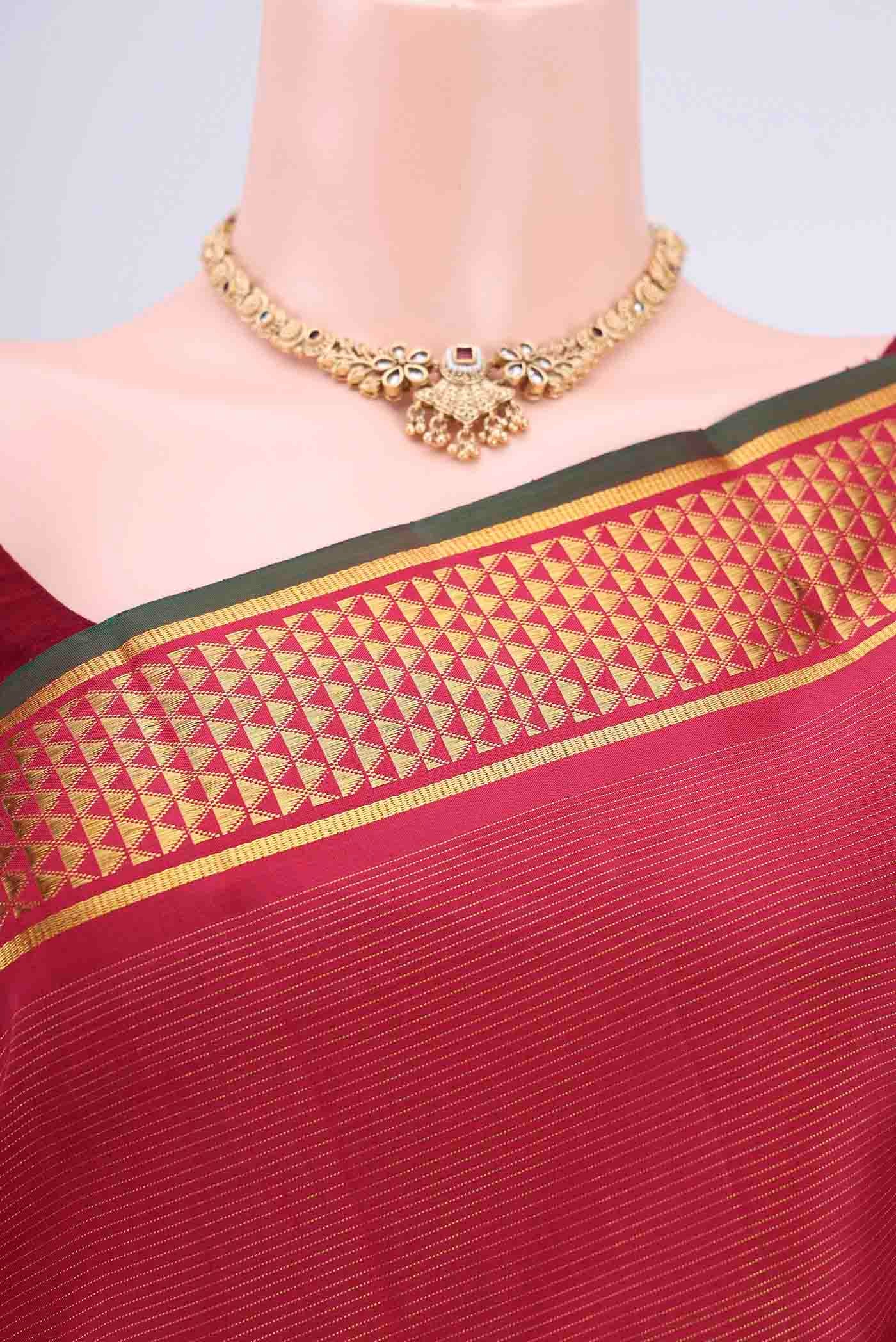 Border image of Maroon Kanchipuram Saree with Stripes on the body and Zari Border. 