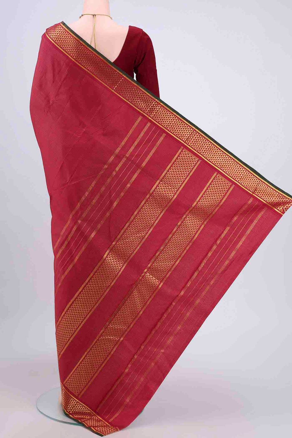 Flat view of Maroon Kanchipuram Saree with Stripes on the body and Zari Border. 