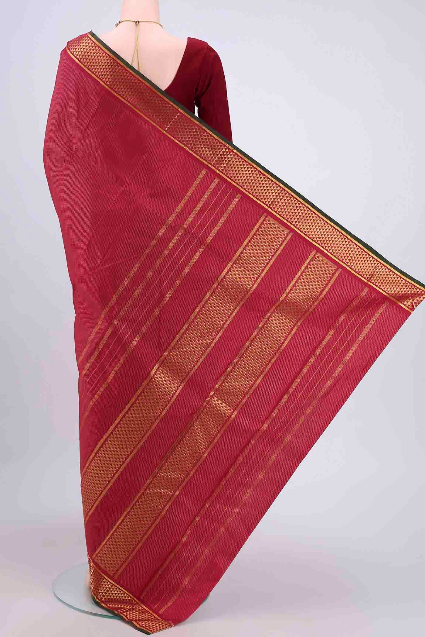 Flat view of Maroon Kanchipuram Saree with Stripes on the body and Zari Border. 