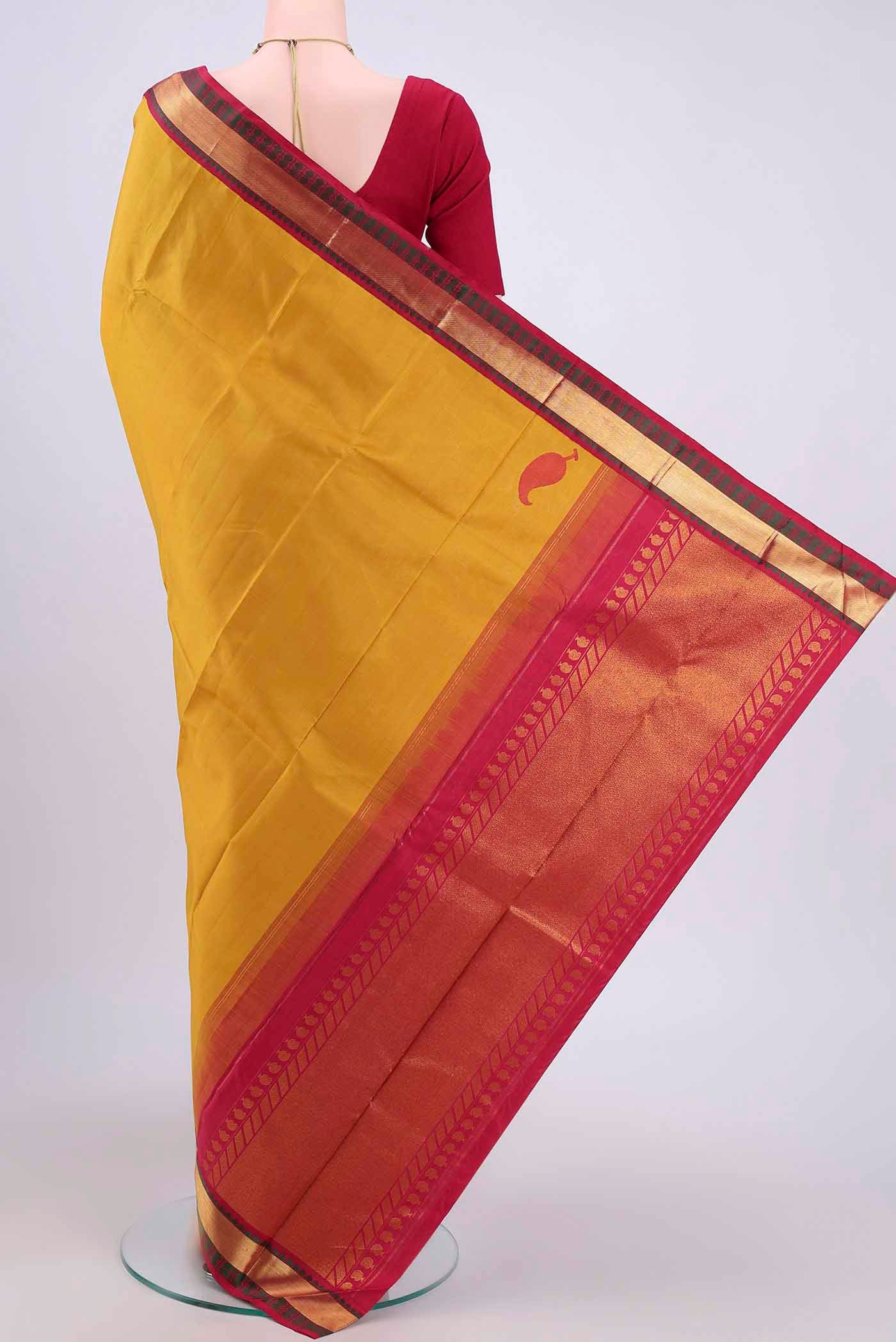 Flat view of Yellow Kanjivaram Saree with Plain Body and Zari Border. 