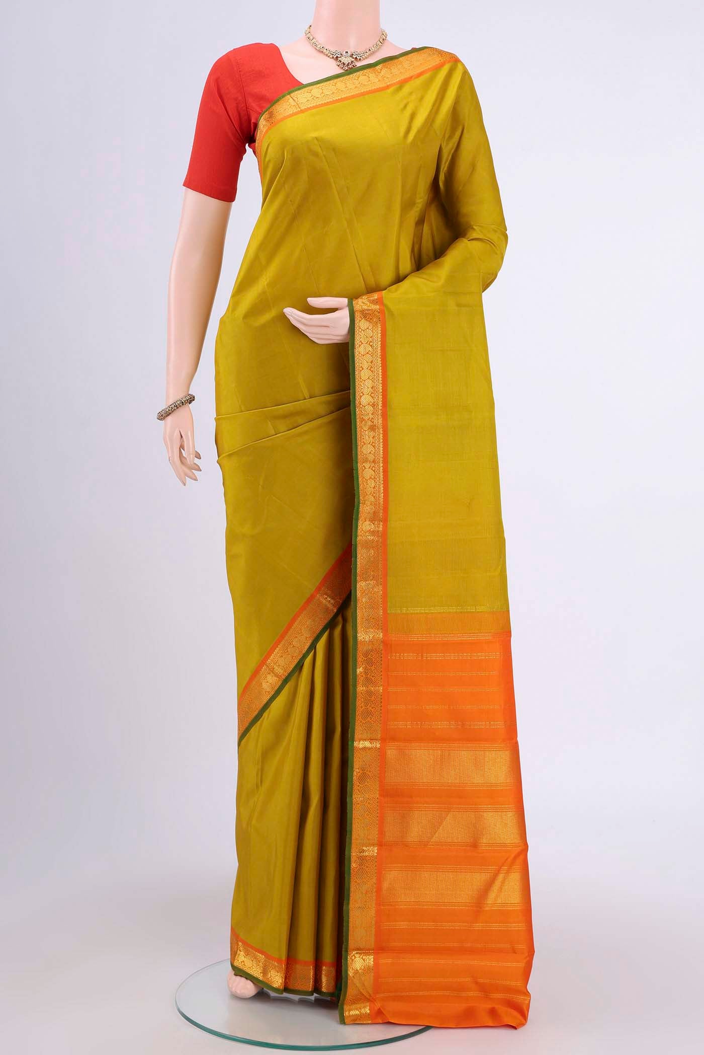 Acid Green Kanchipuram Saree with Plain Body and Zari Border displayed on a mannequin