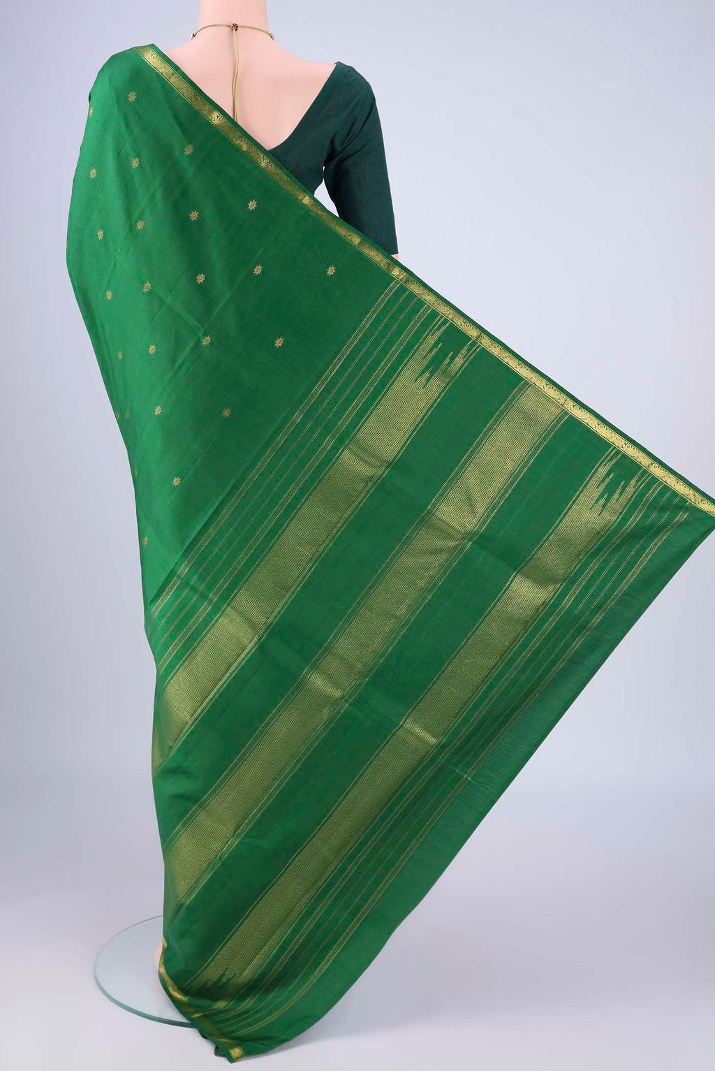 Flat view of Green Kanchipuram Silk Saree with Zari Butta on the body and Zari Border. 