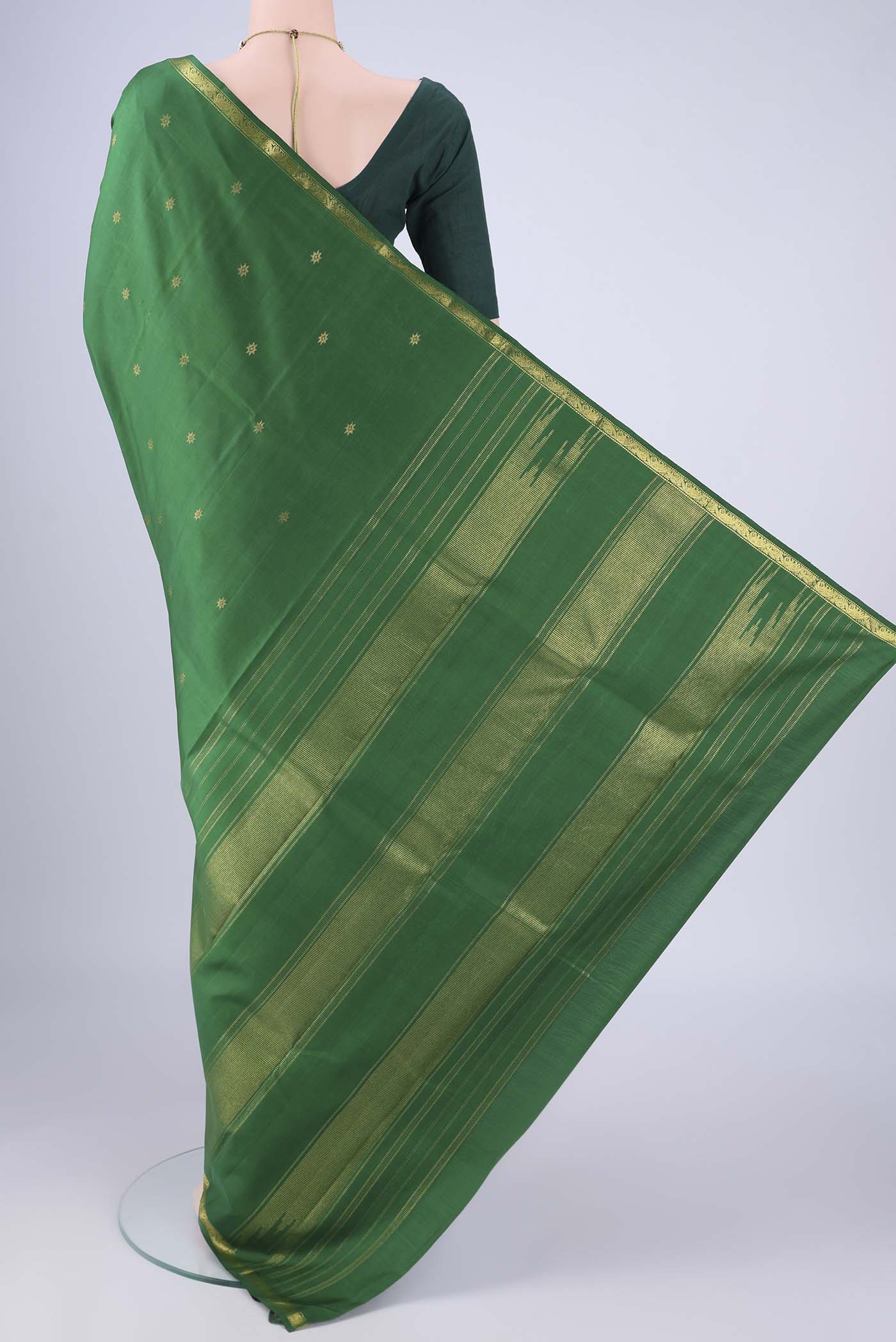 Flat view of Green Kanchipuram Silk Saree with Zari Butta on the body and Zari Border. 