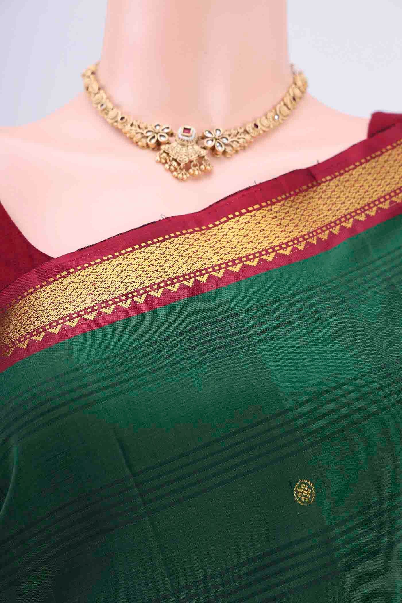 Border image of Bottle Green Kanchipuram Saree with Zari Butta on the body and Zari Border. 