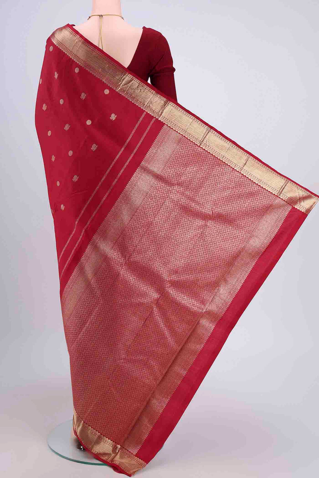 Flat view of Maroon Kanjivaram Saree with Zari Butta on the body and Zari Border. 
