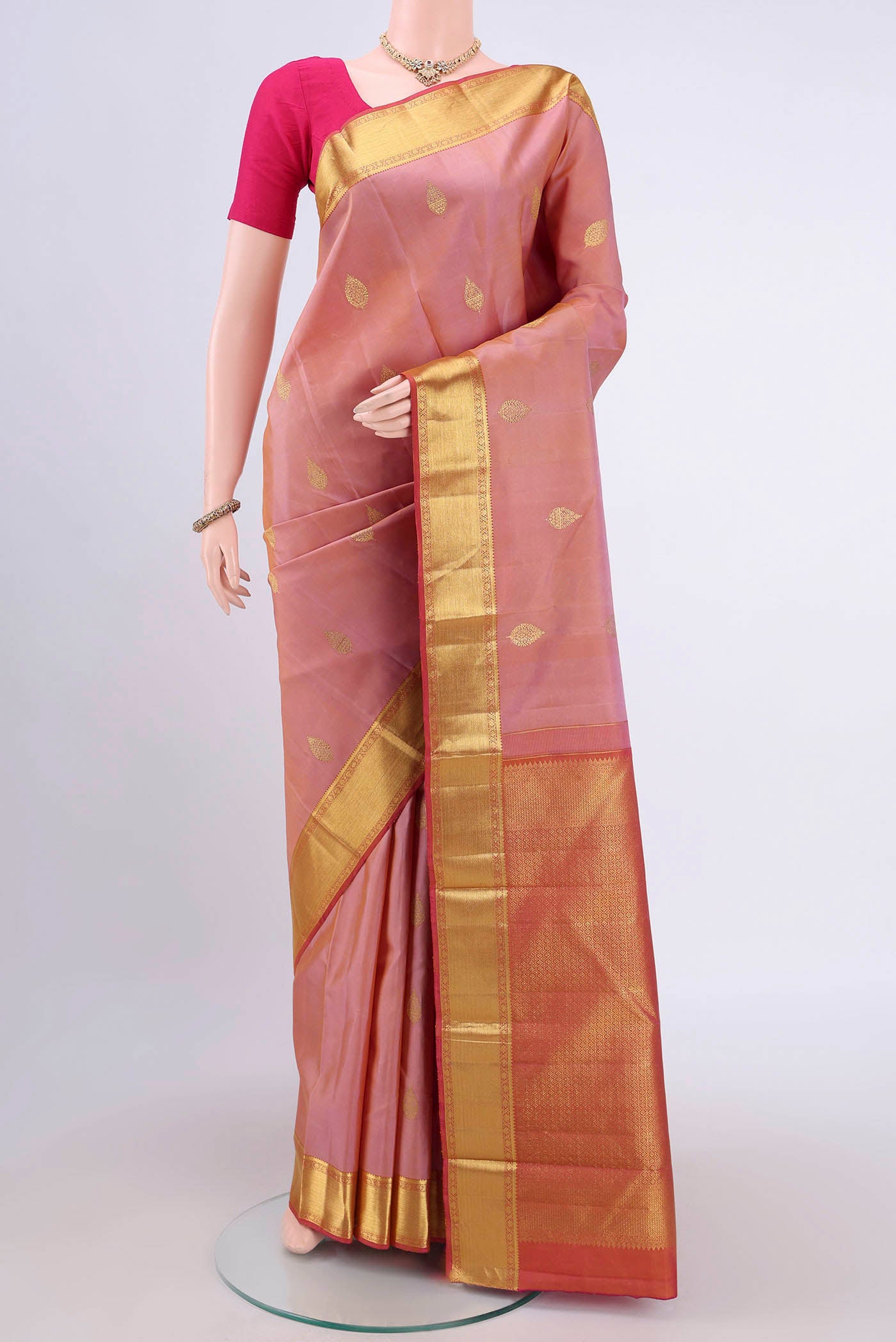 Peach Dual Tone Nangavalli Silk [ Salem ] Saree with Zari Butta on the body and Zari Border.  displayed on a mannequin