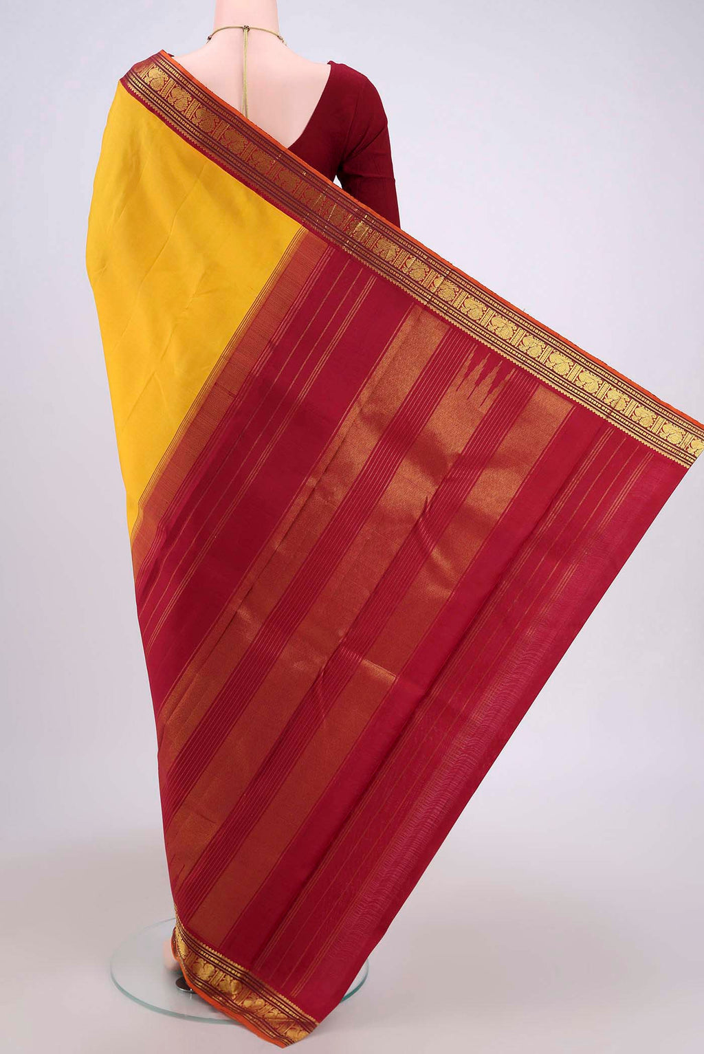 Flat view of Yellow Kanjivaram Silk Saree with Plain Body and Zari Border. 