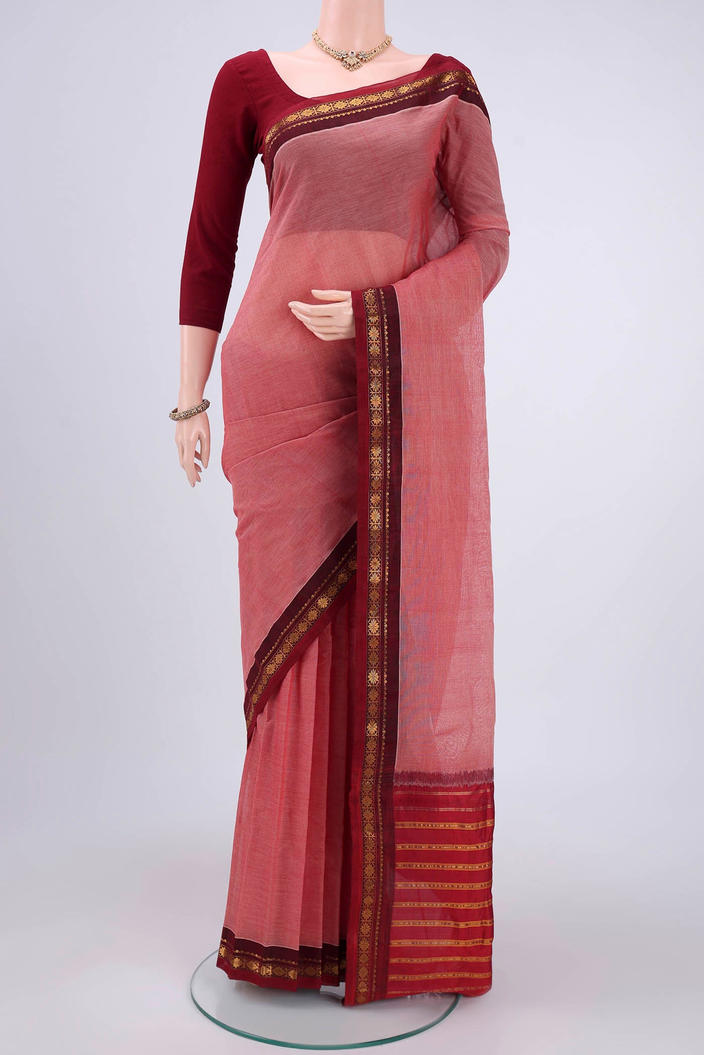 Peach Gadwal Silk Cotton Saree with Plain Body and Zari Border.  displayed on a mannequin