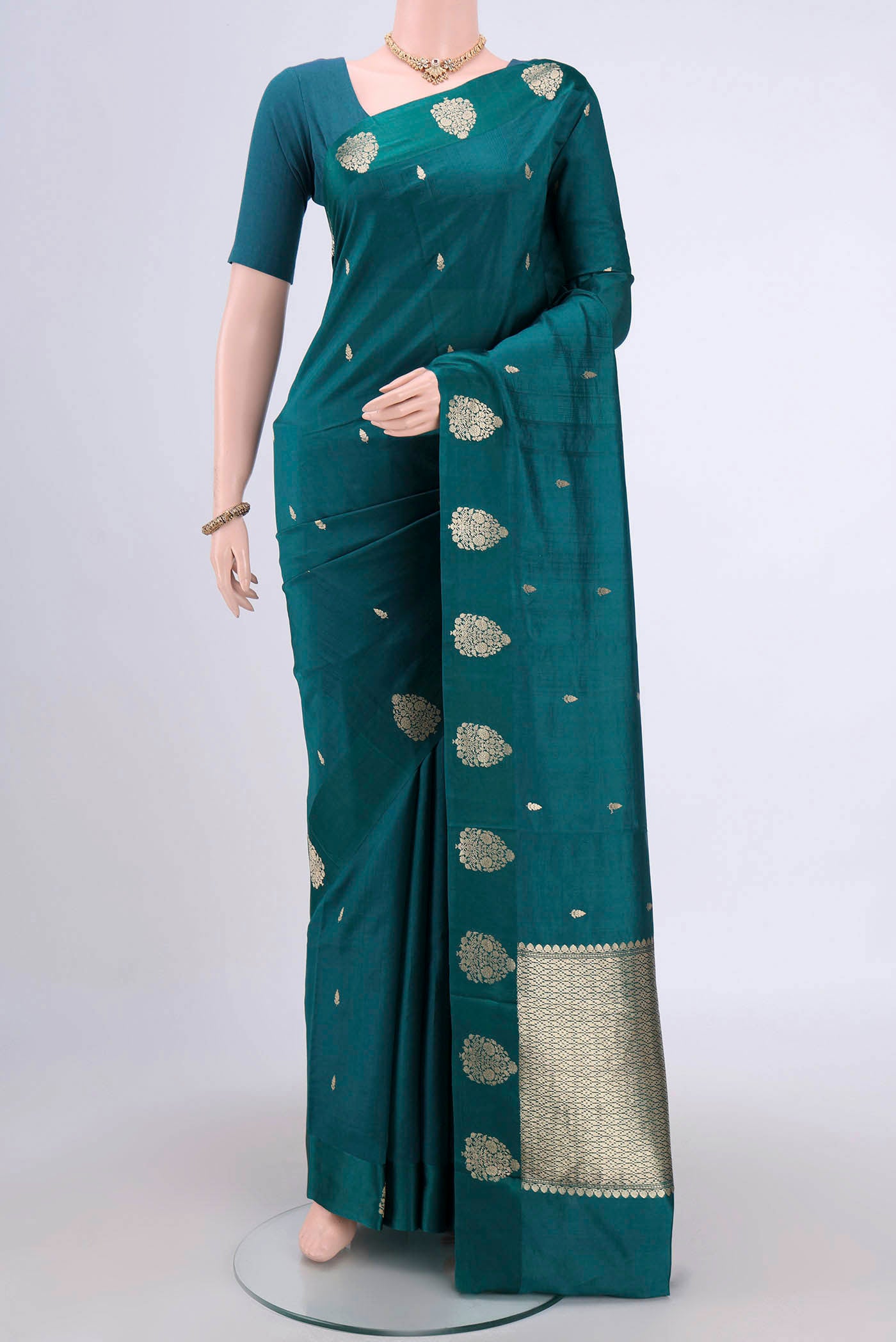 Sea Green Banarasi Katan Silk Saree with Zari Butta on the body and Zari Border.  displayed on a mannequin