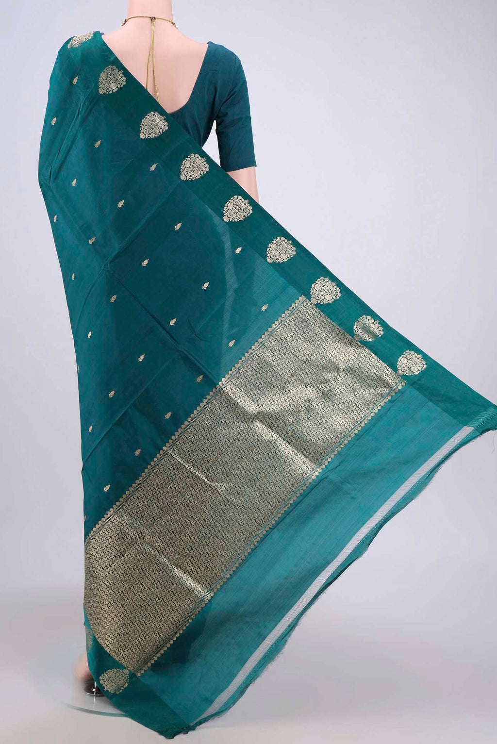 Flat view of Sea Green Banarasi Katan Silk Saree with Zari Butta on the body and Zari Border. 