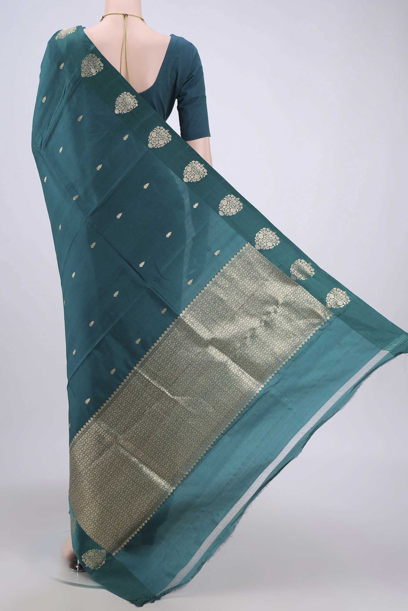 Flat view of Sea Green Banarasi Katan Silk Saree with Zari Butta on the body and Zari Border. 