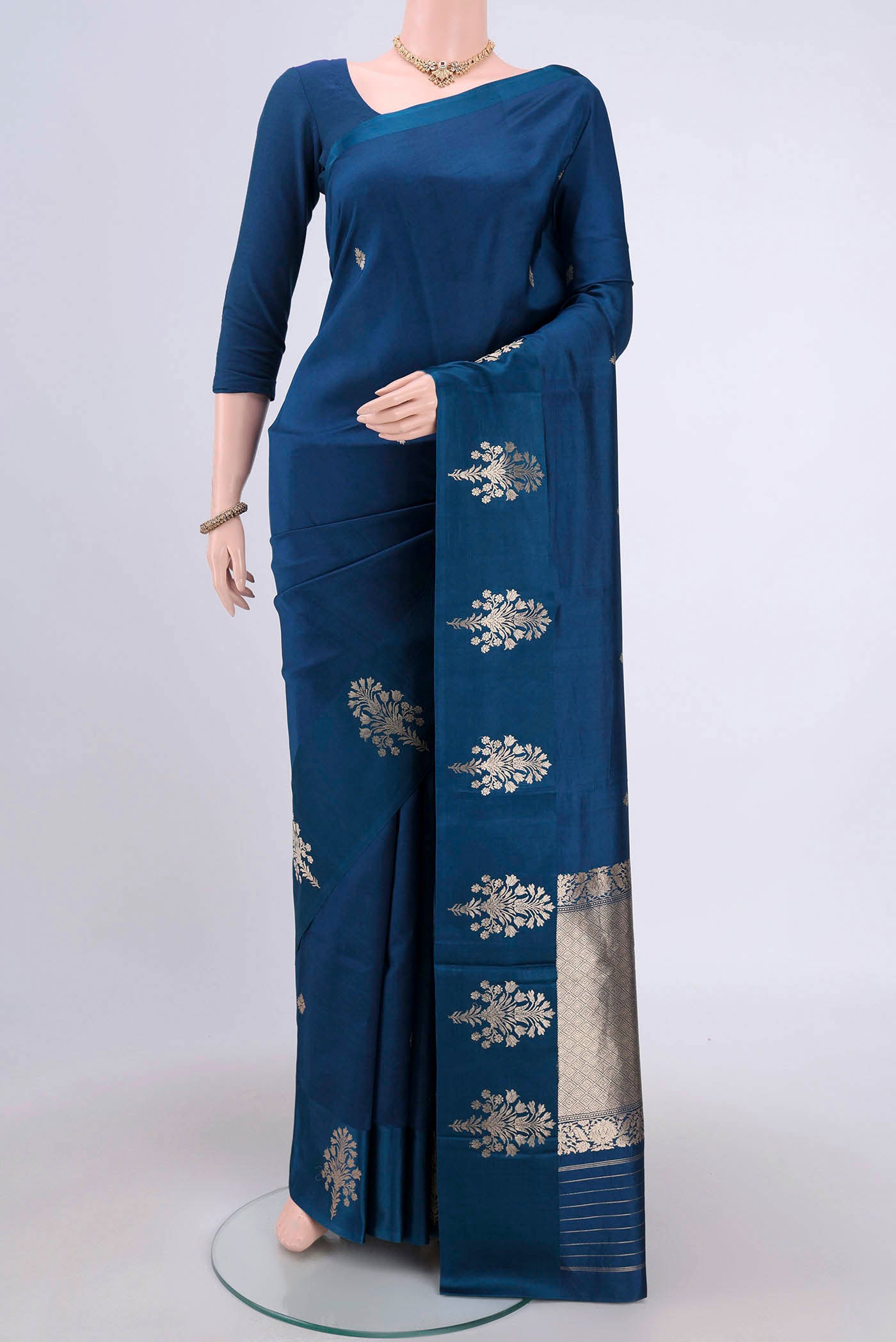Blue Banarasi Katan Silk Saree with Zari Butta on the body and Zari Border.  displayed on a mannequin