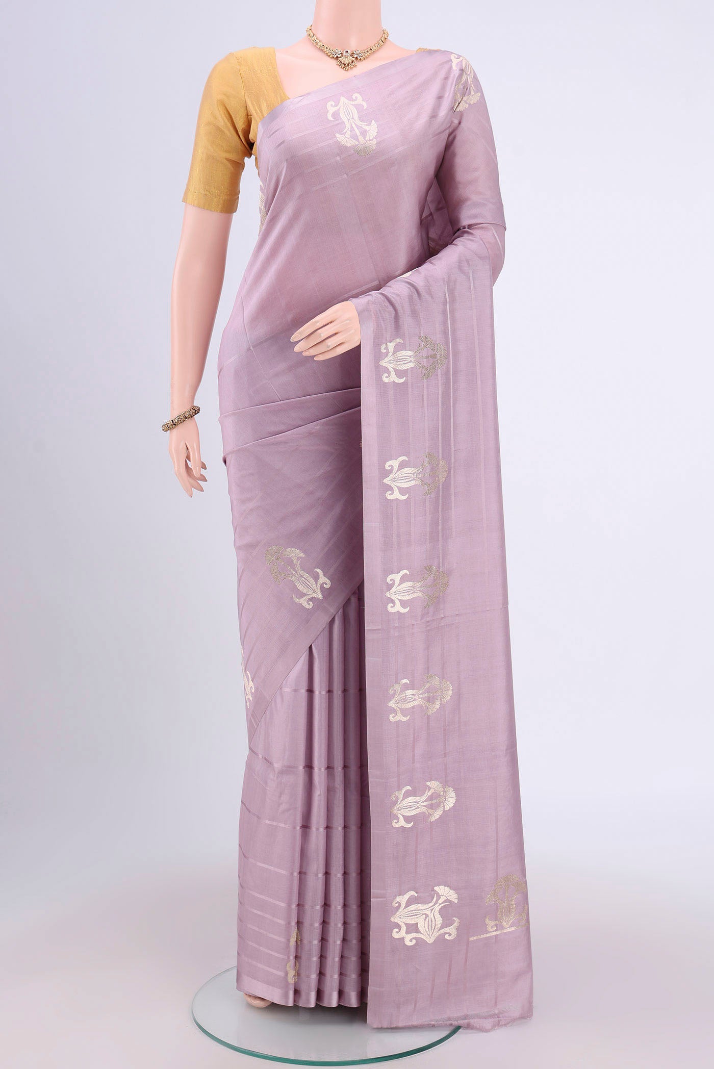 Lilac Banarasi Katan Silk Saree with Plain Body and Zari Border.  displayed on a mannequin