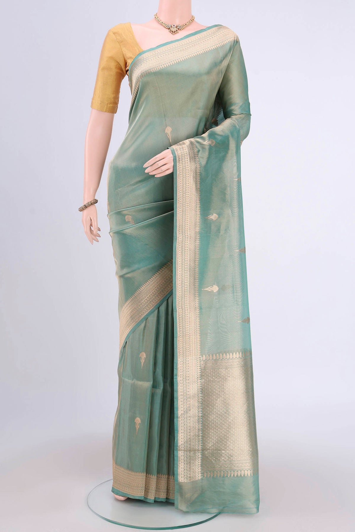 Sea Green Banarasi Tissue Silk Saree with Zari Butta on the body and Zari Border.  displayed on a mannequin