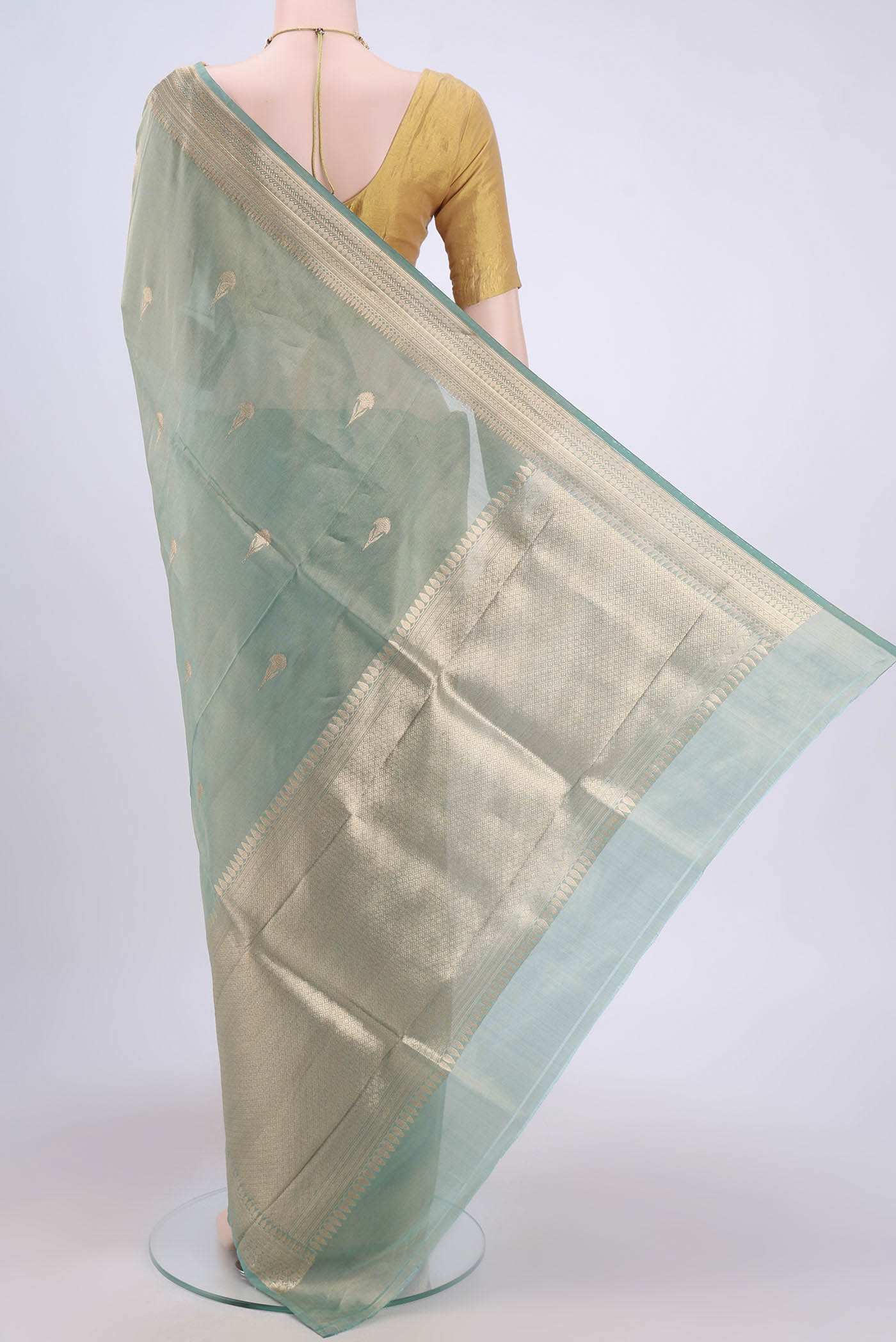 Flat view of Sea Green Banarasi Tissue Silk Saree with Zari Butta on the body and Zari Border. 