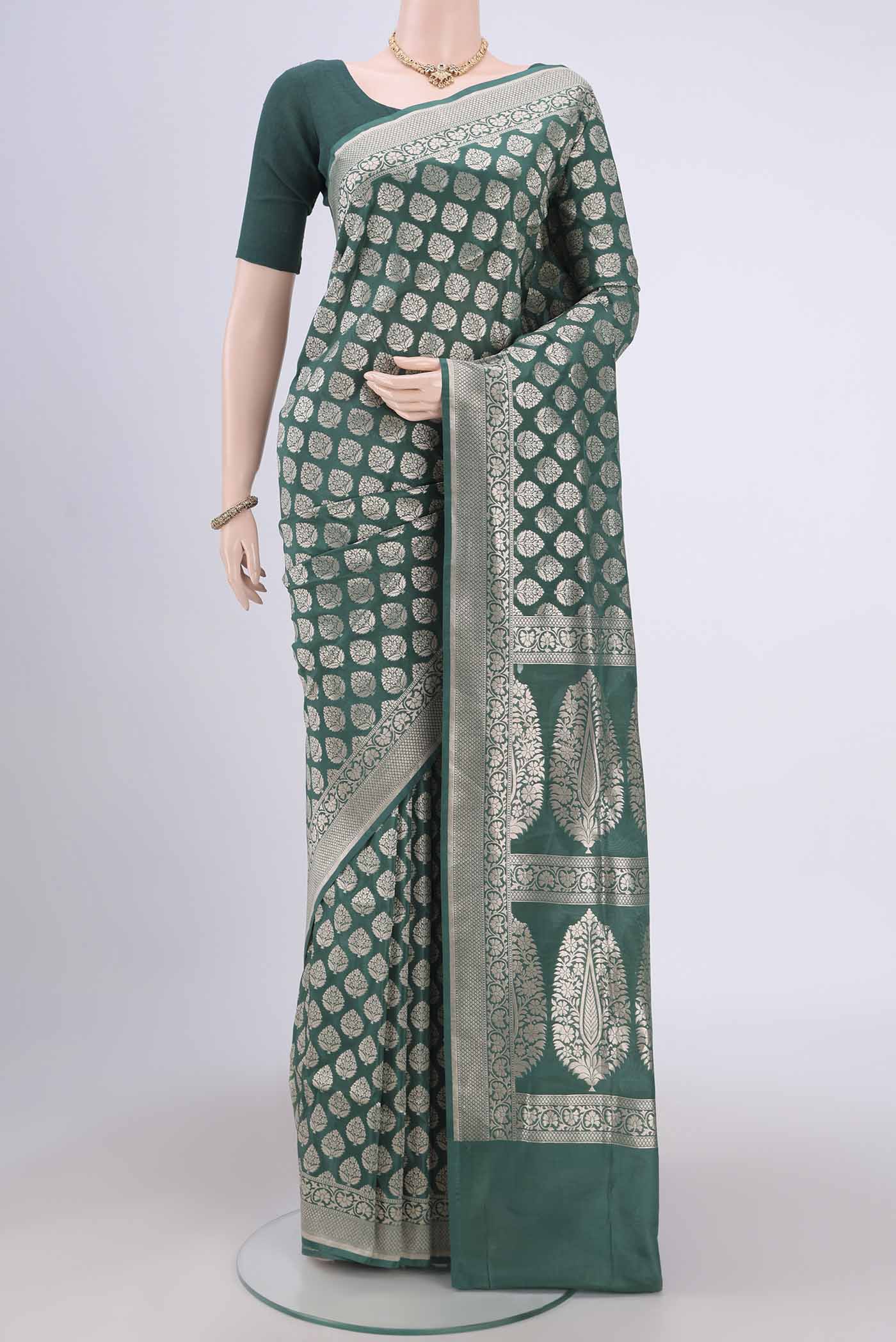 Green Banarasi Jamavar Saree with Zari Brocade on the body and Zari Border.  displayed on a mannequin