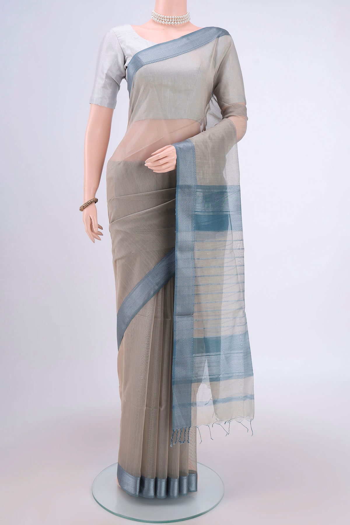 Davys Grey Maheshwari Silk Cotton Saree with Stripes on the body and Zari Border.  displayed on a mannequin