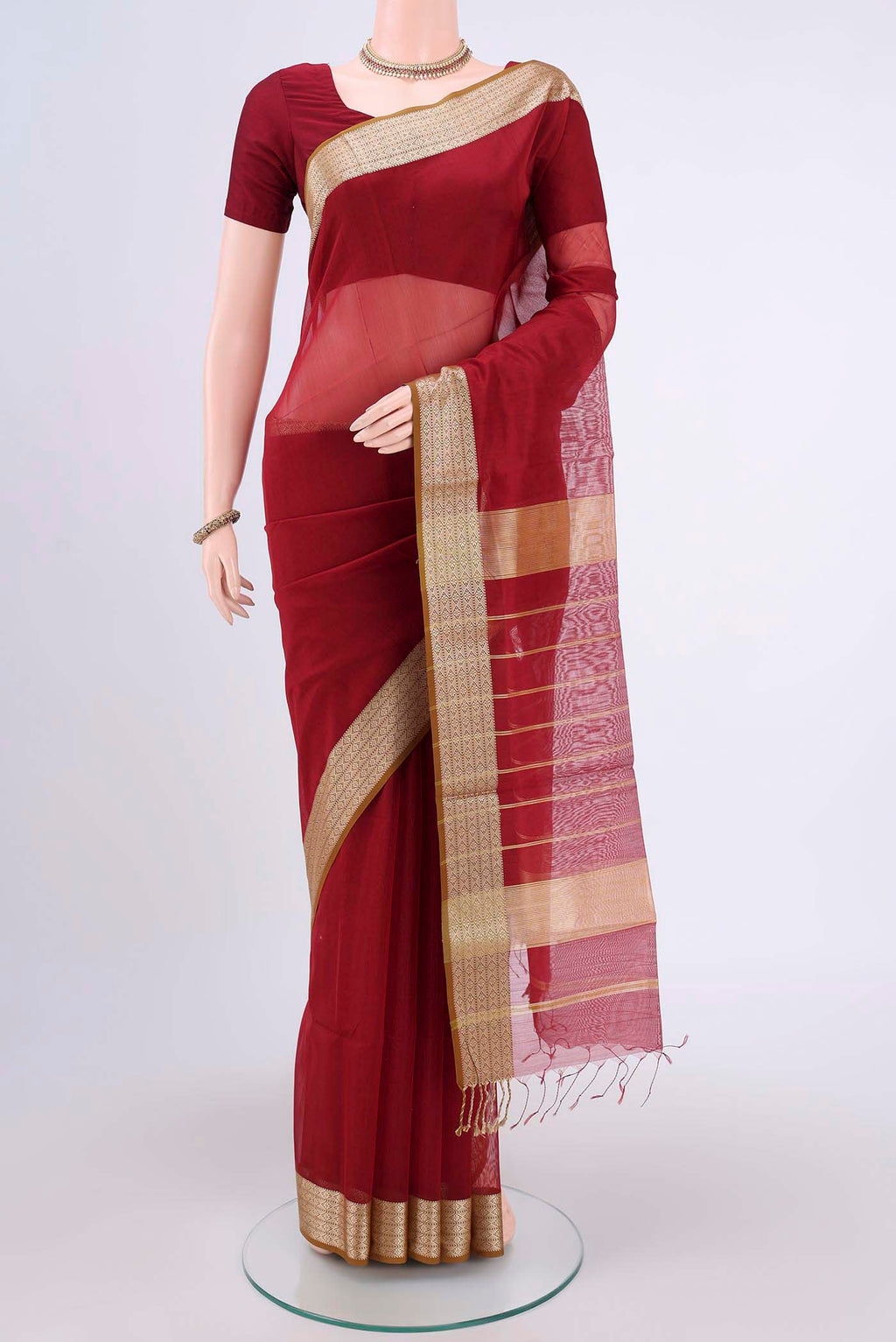 Maroon Maheshwari Silk Cotton Saree with Plain Body and Thread Border.  displayed on a mannequin